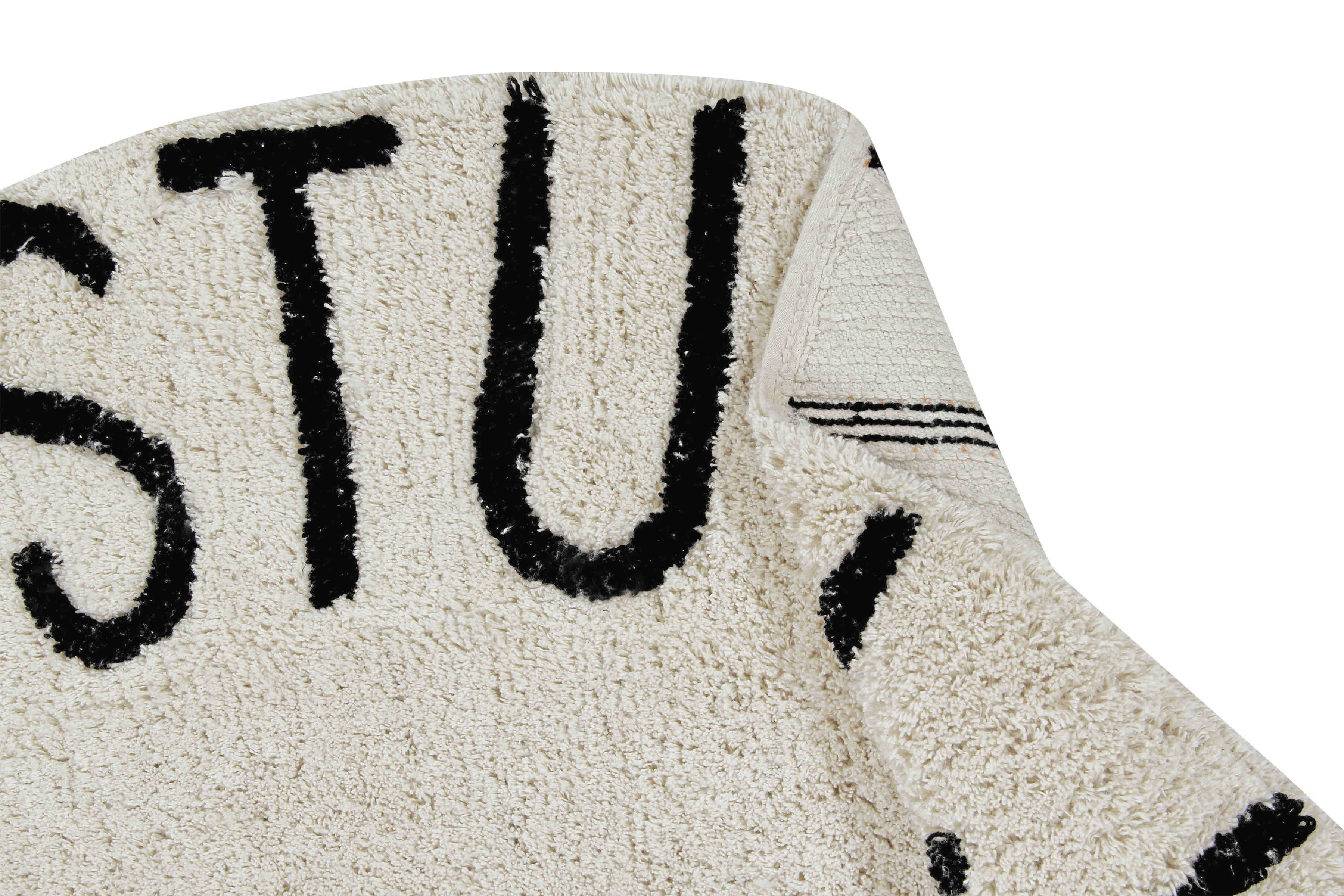 Circular white cotton rug decorated with a black alphabet border