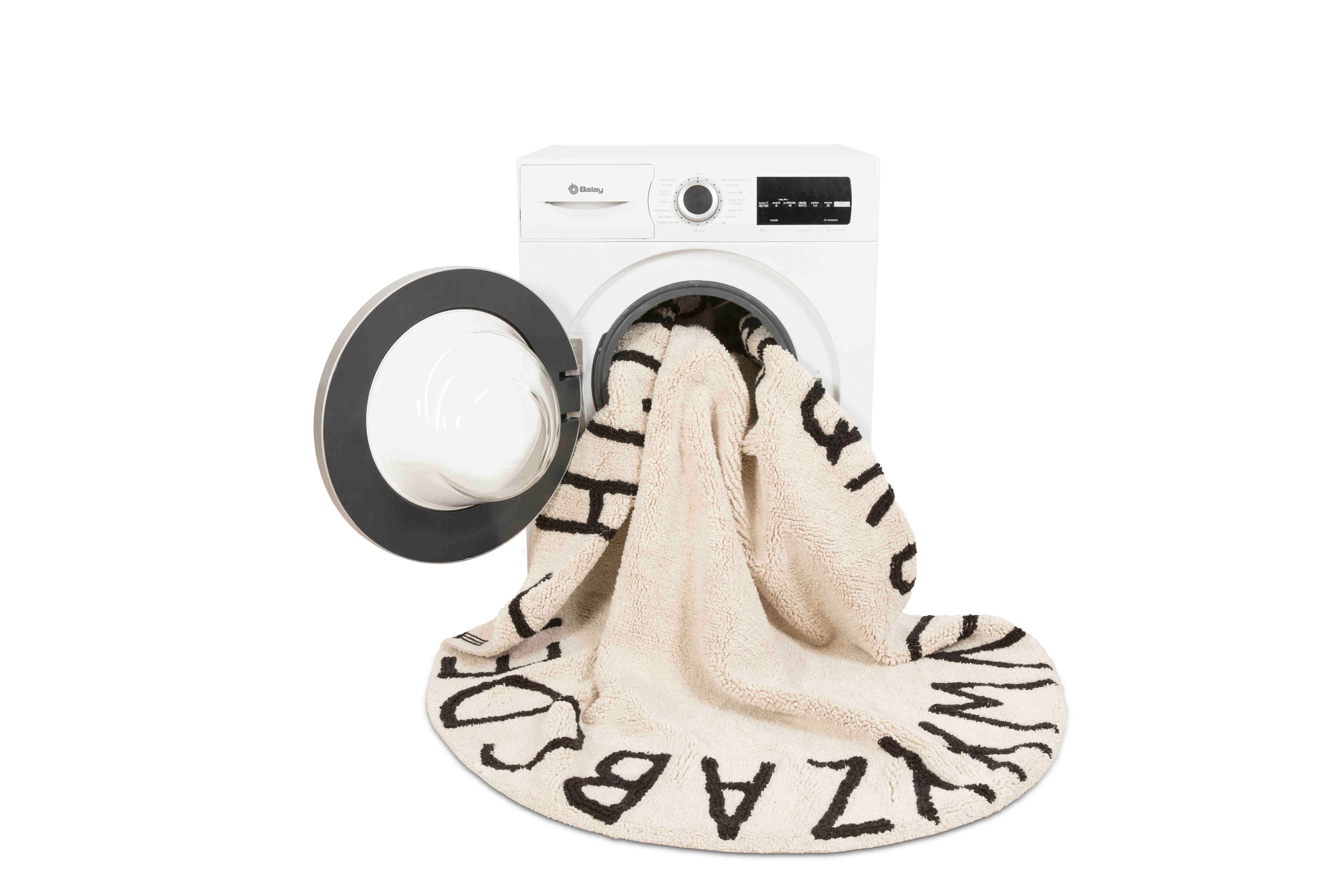 Circular white cotton rug decorated with a black alphabet border