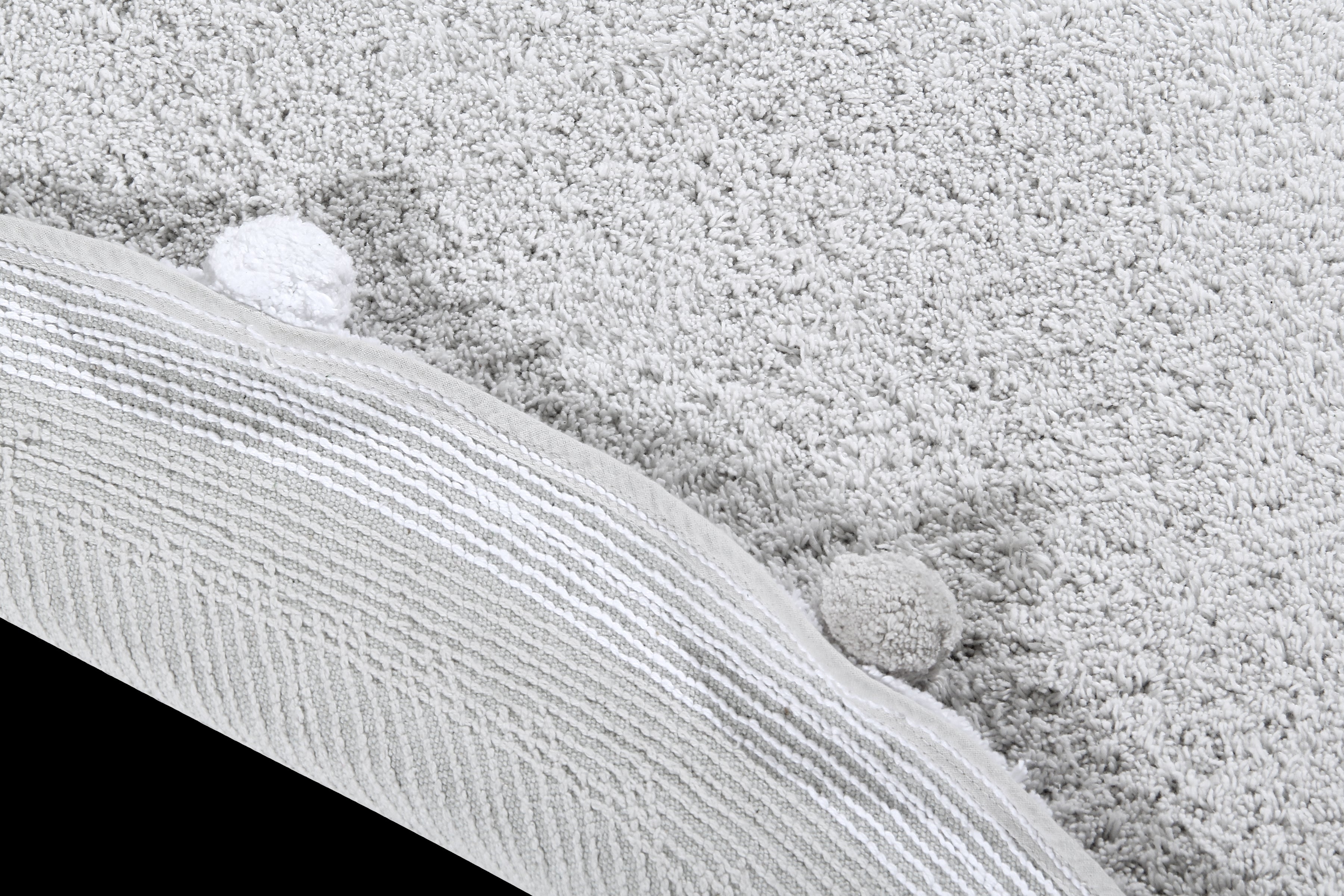 Circular grey pom pom rug with grey and white pom pom border