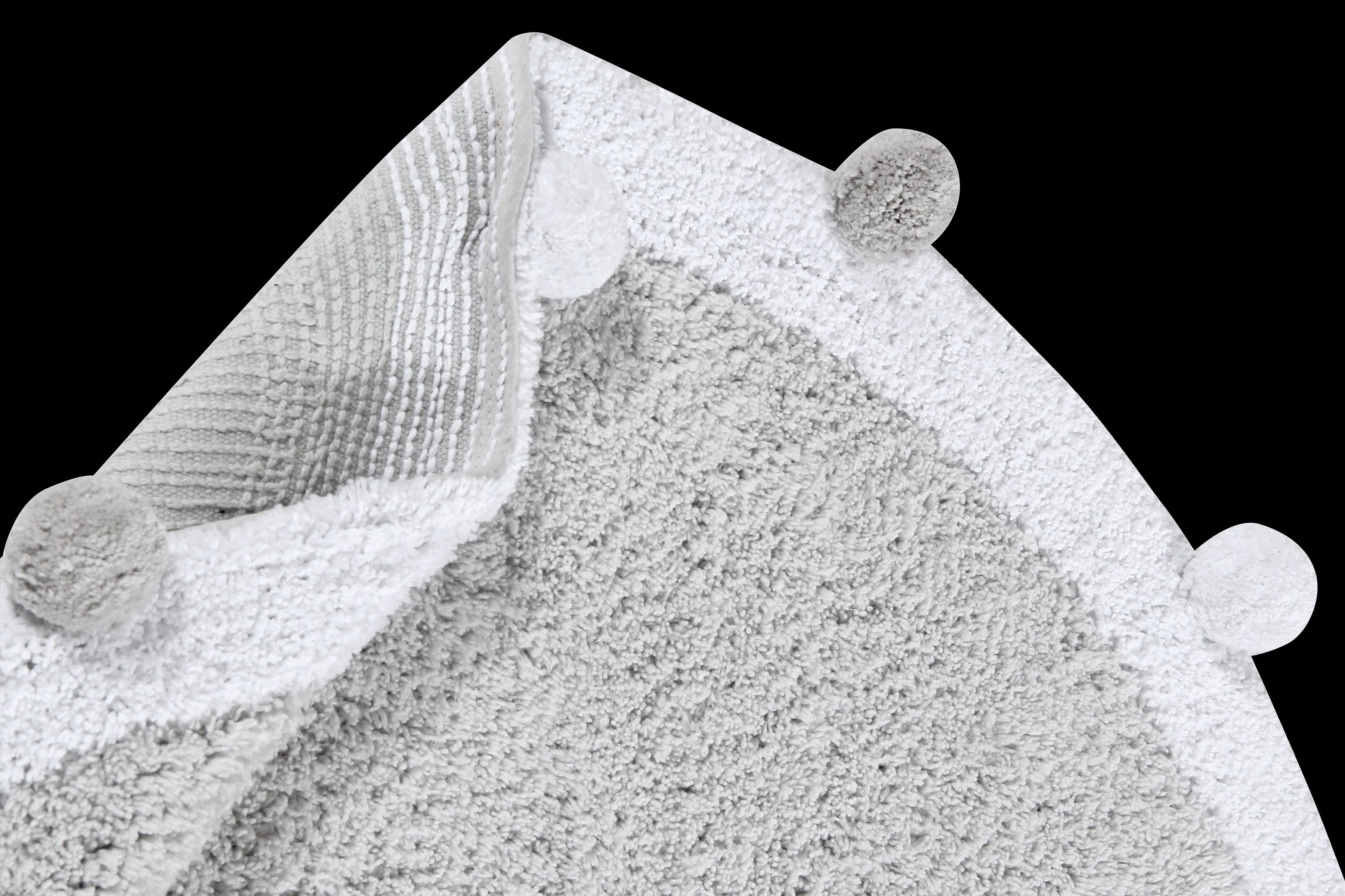 Circular grey pom pom rug with grey and white pom pom border