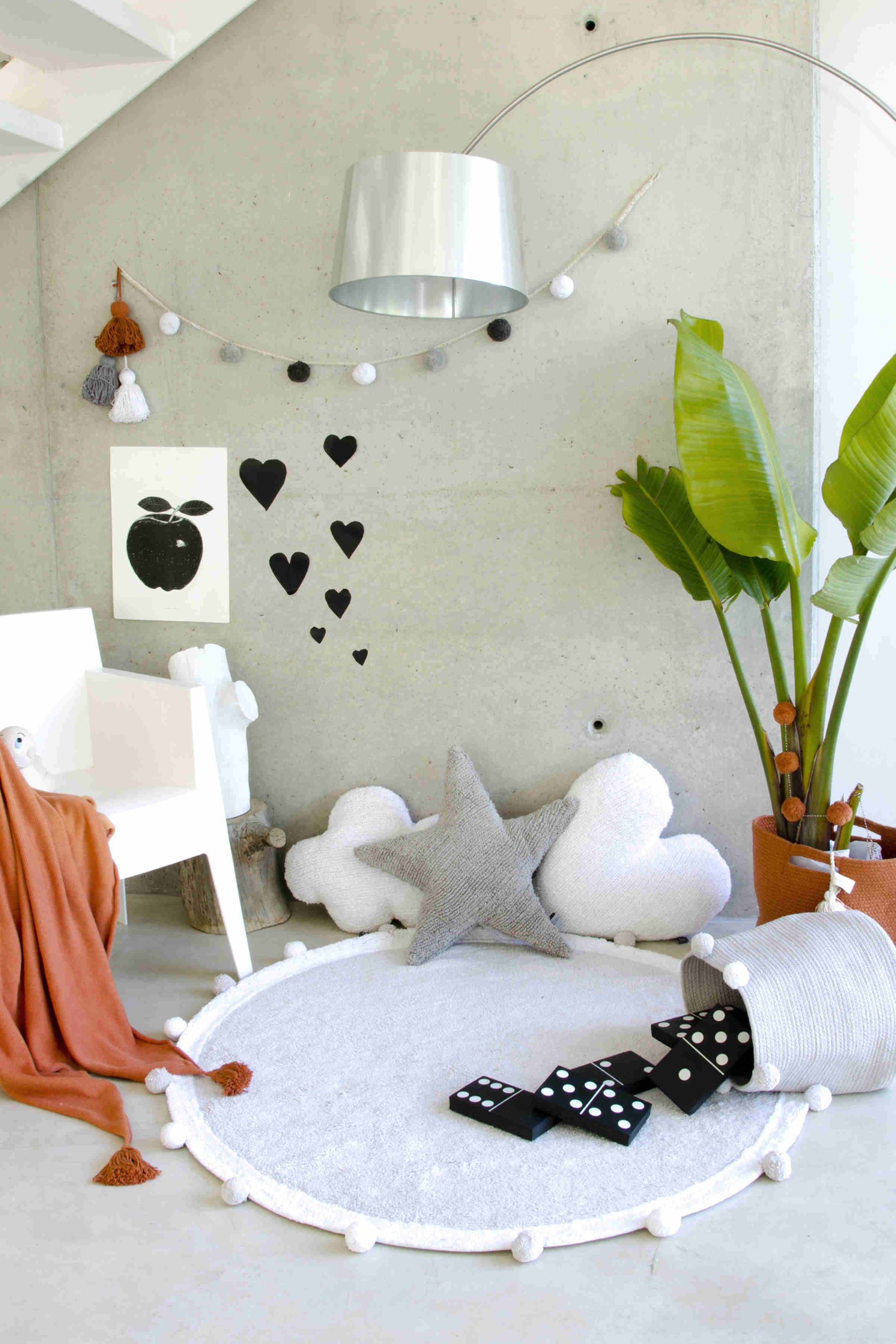 Circular grey pom pom rug with grey and white pom pom border