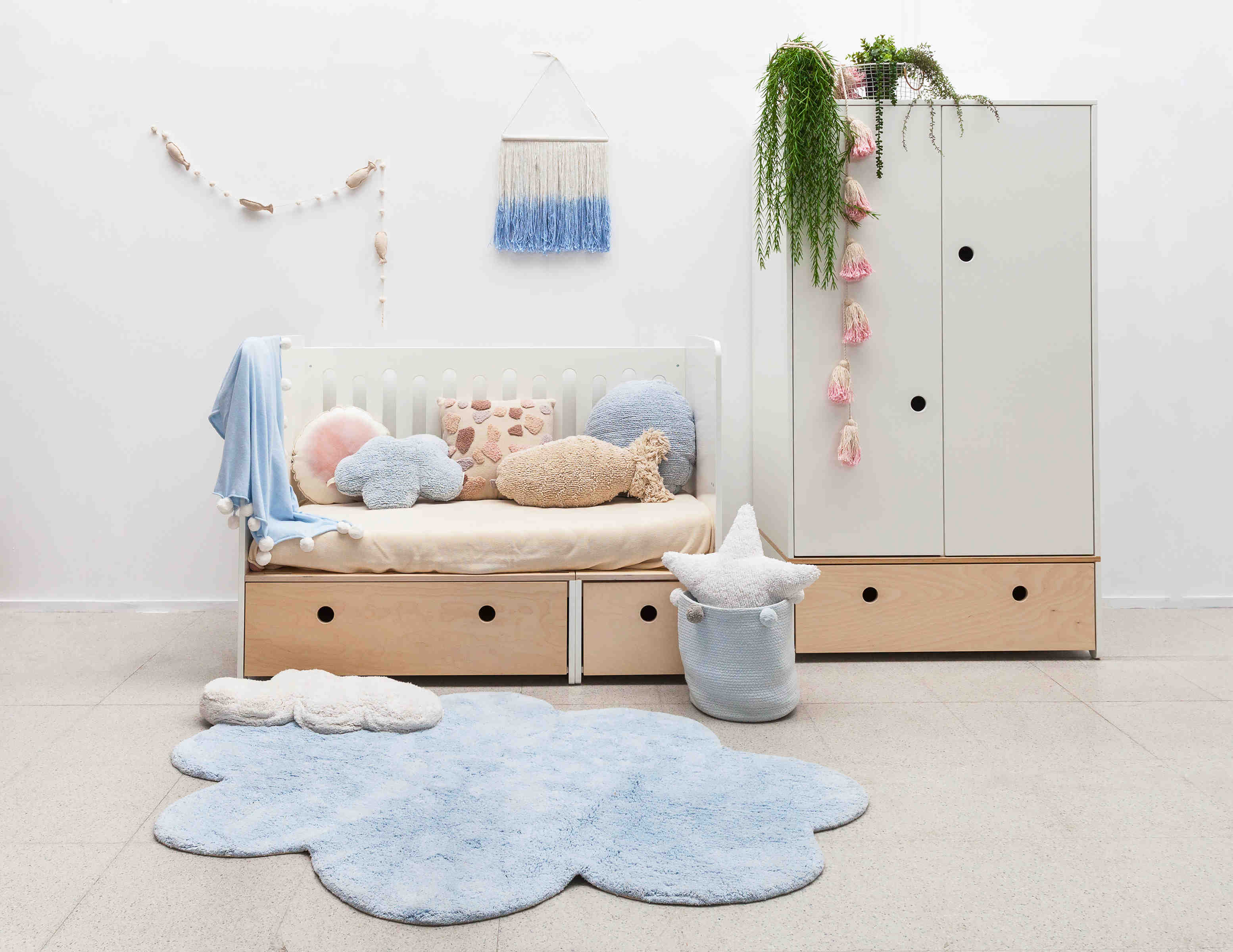 A large blue cotton rug shaped like a cloud