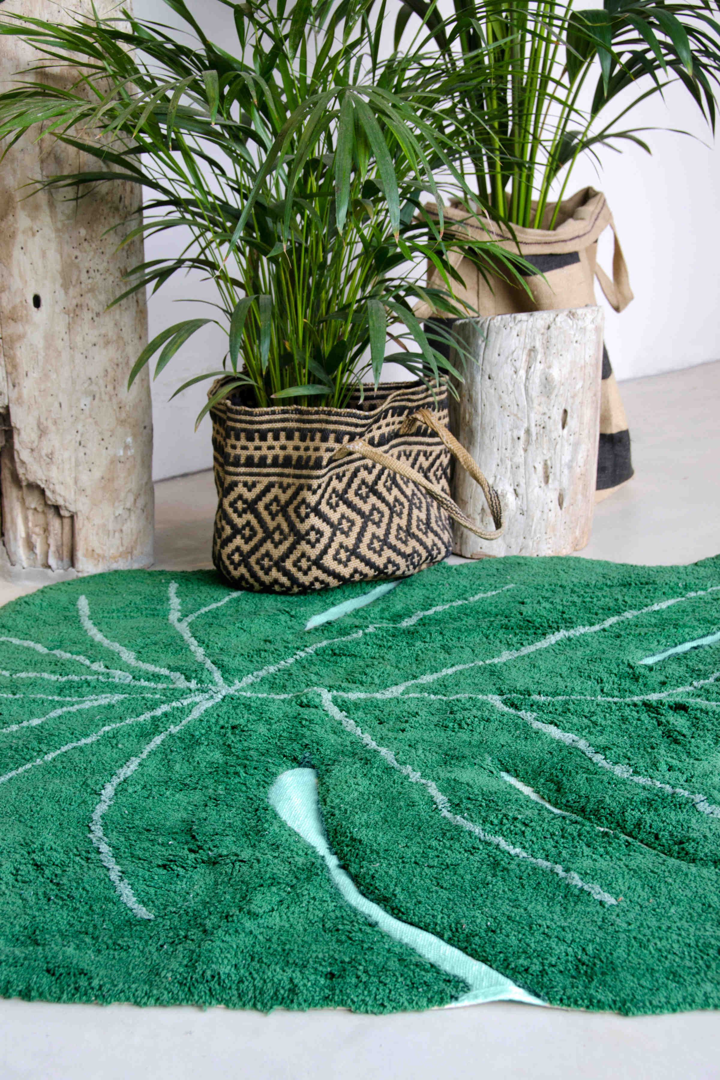 A large green leaf-shaped rug