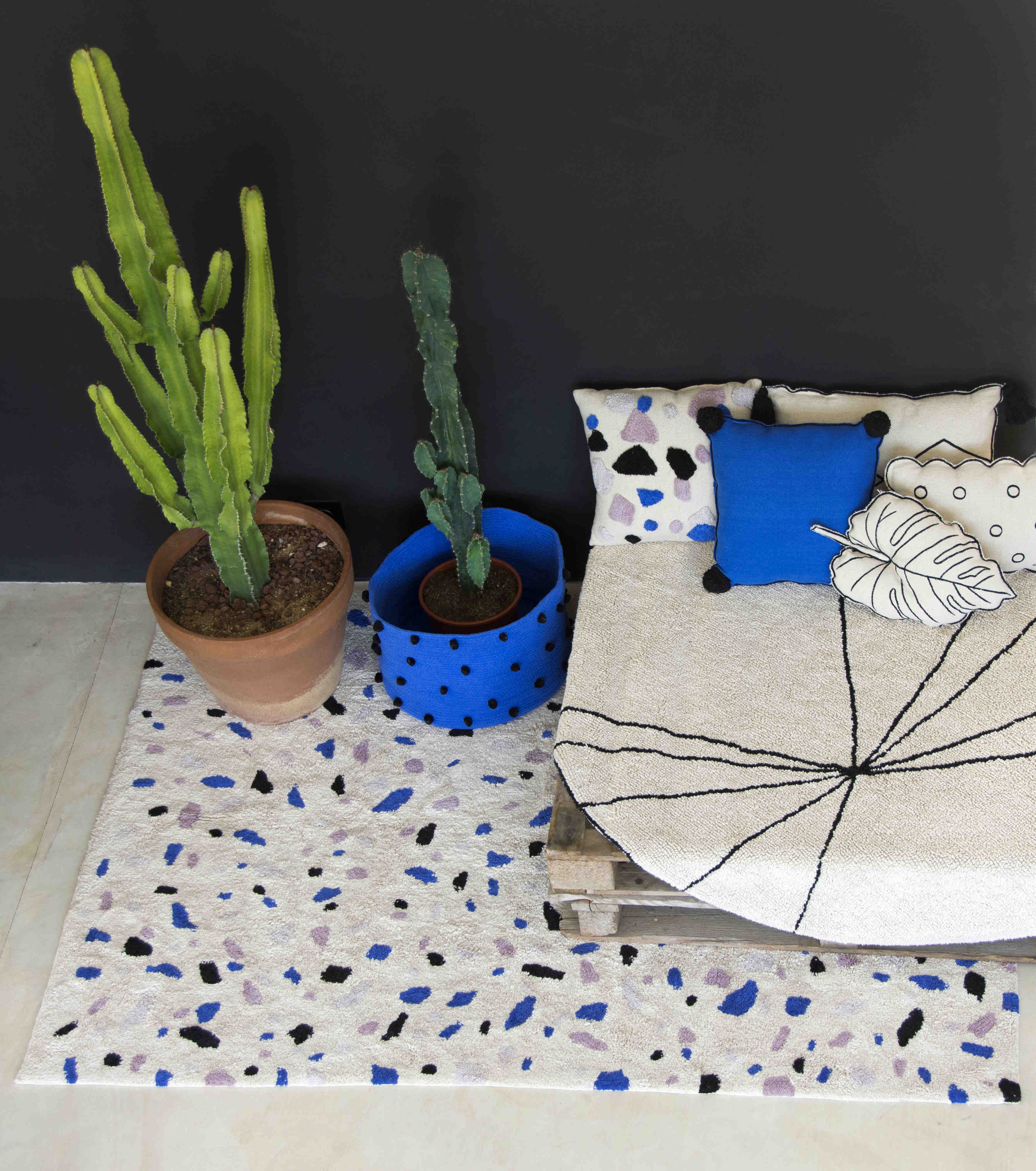 A circular shaped beige cotton rug decorated with geometric black lines