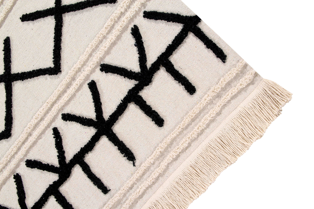 Rectangular beige cotton rug decorated with a black moroccan tribal design and a fringed border