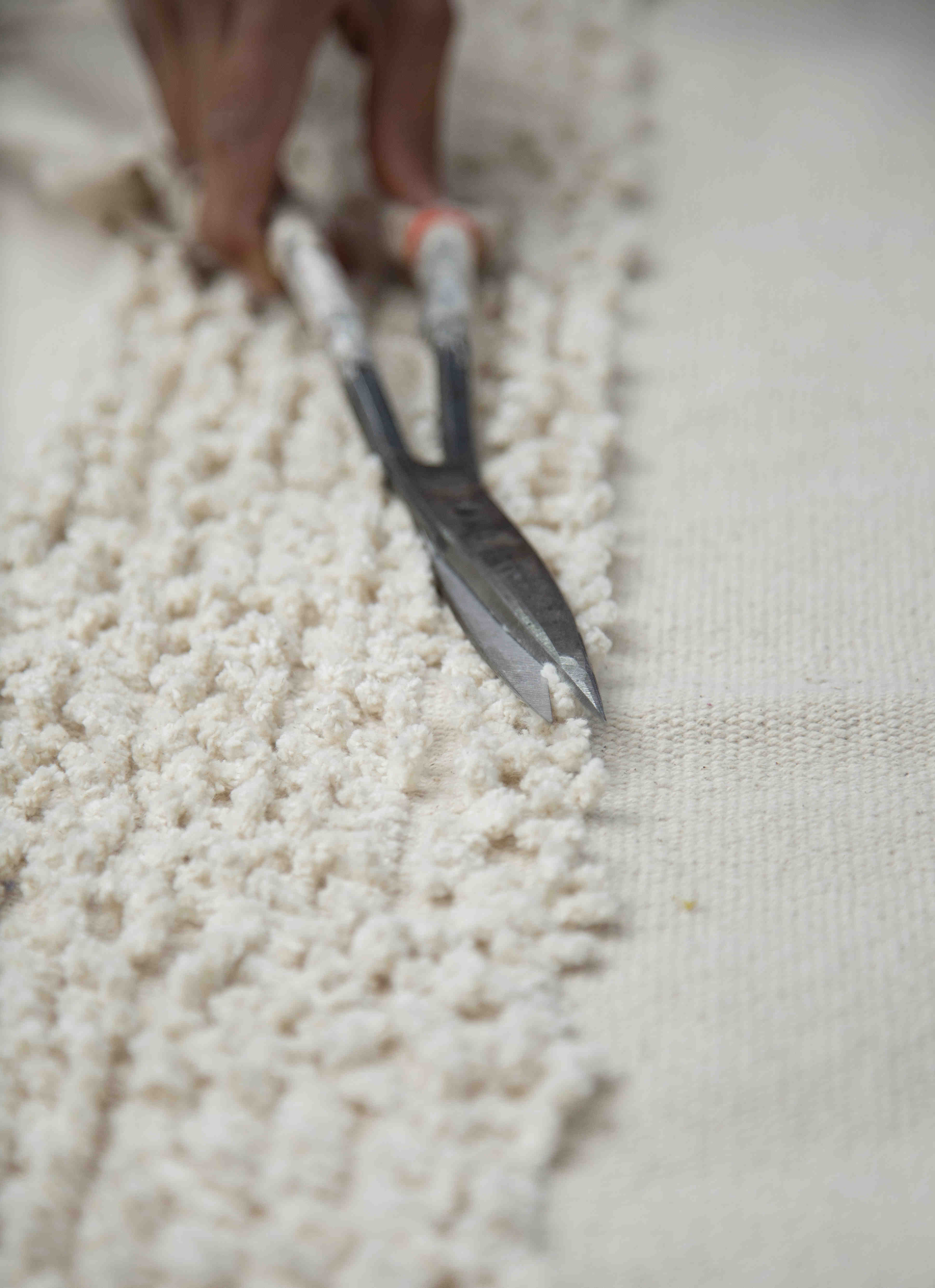 Rectangular natural beige rug decorated with a raised textured stripe pattern