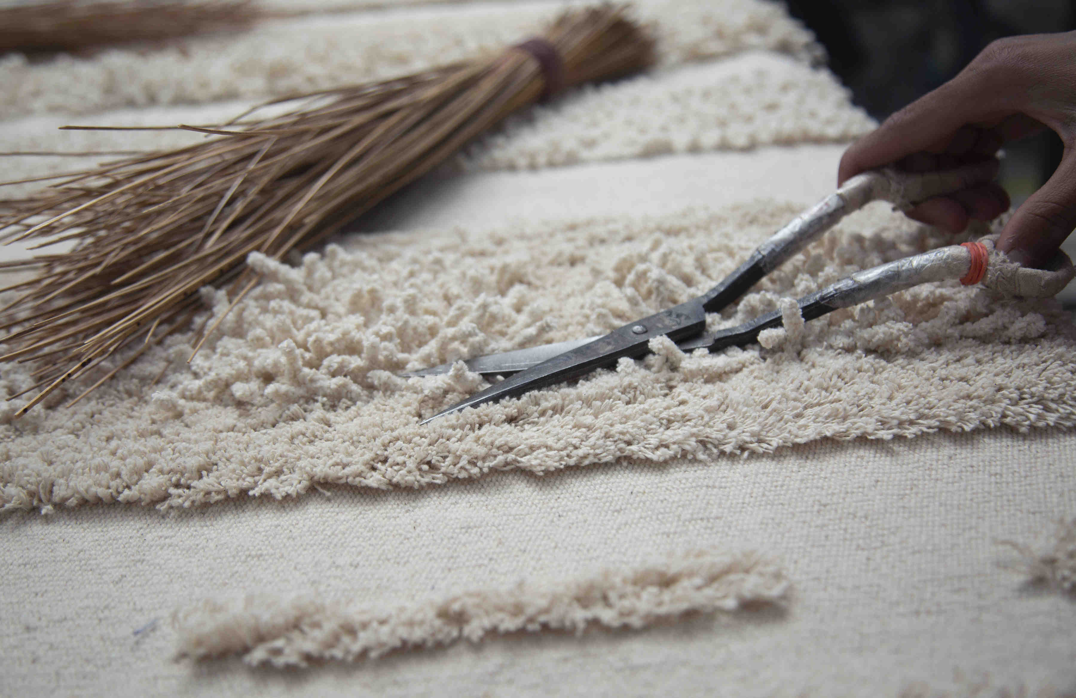 Rectangular natural beige rug decorated with a raised textured stripe pattern