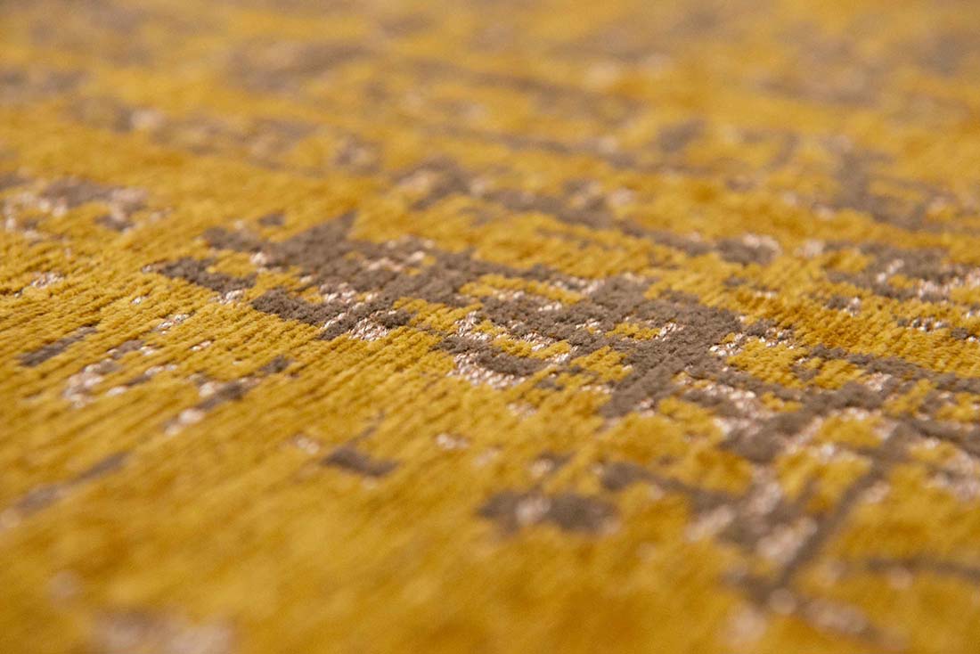 gold flatweave area rug with abstract design
