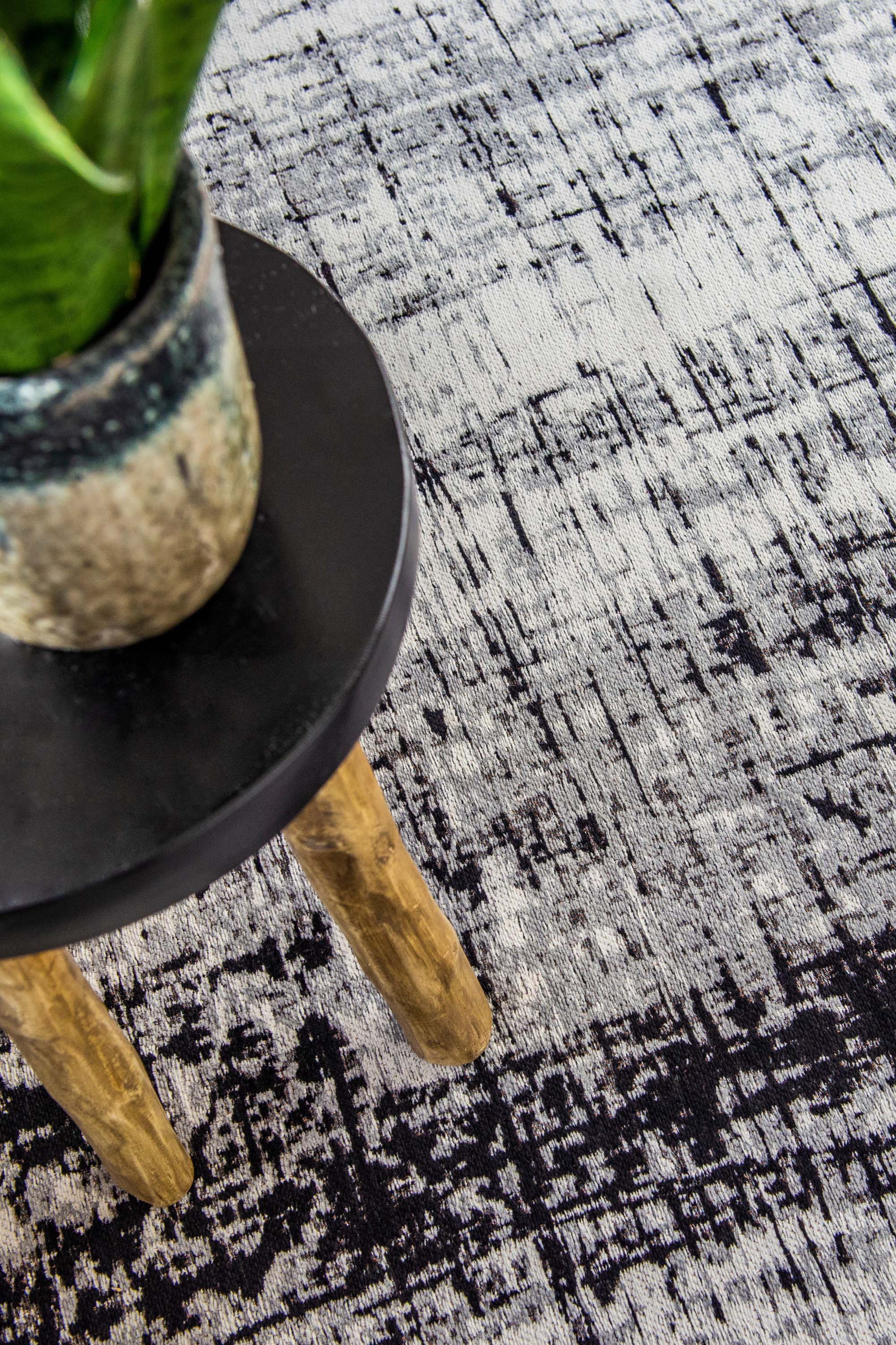 White flatweave rug with grey and black abstract pattern