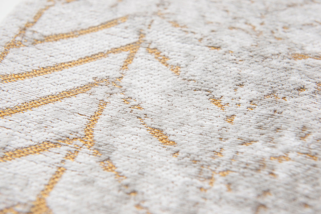 White flatweave rug with faded yellow chevron pattern