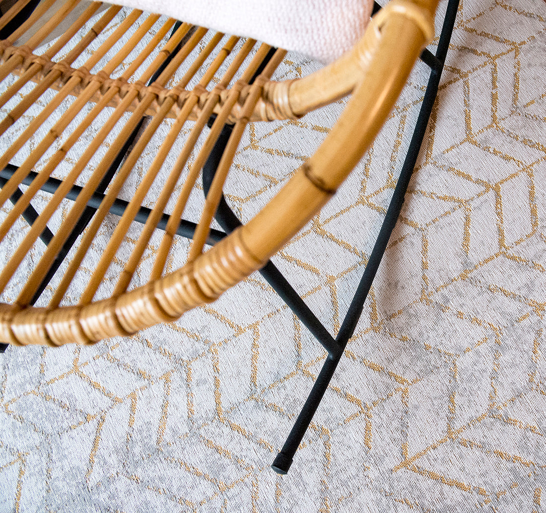 White flatweave rug with faded yellow chevron pattern