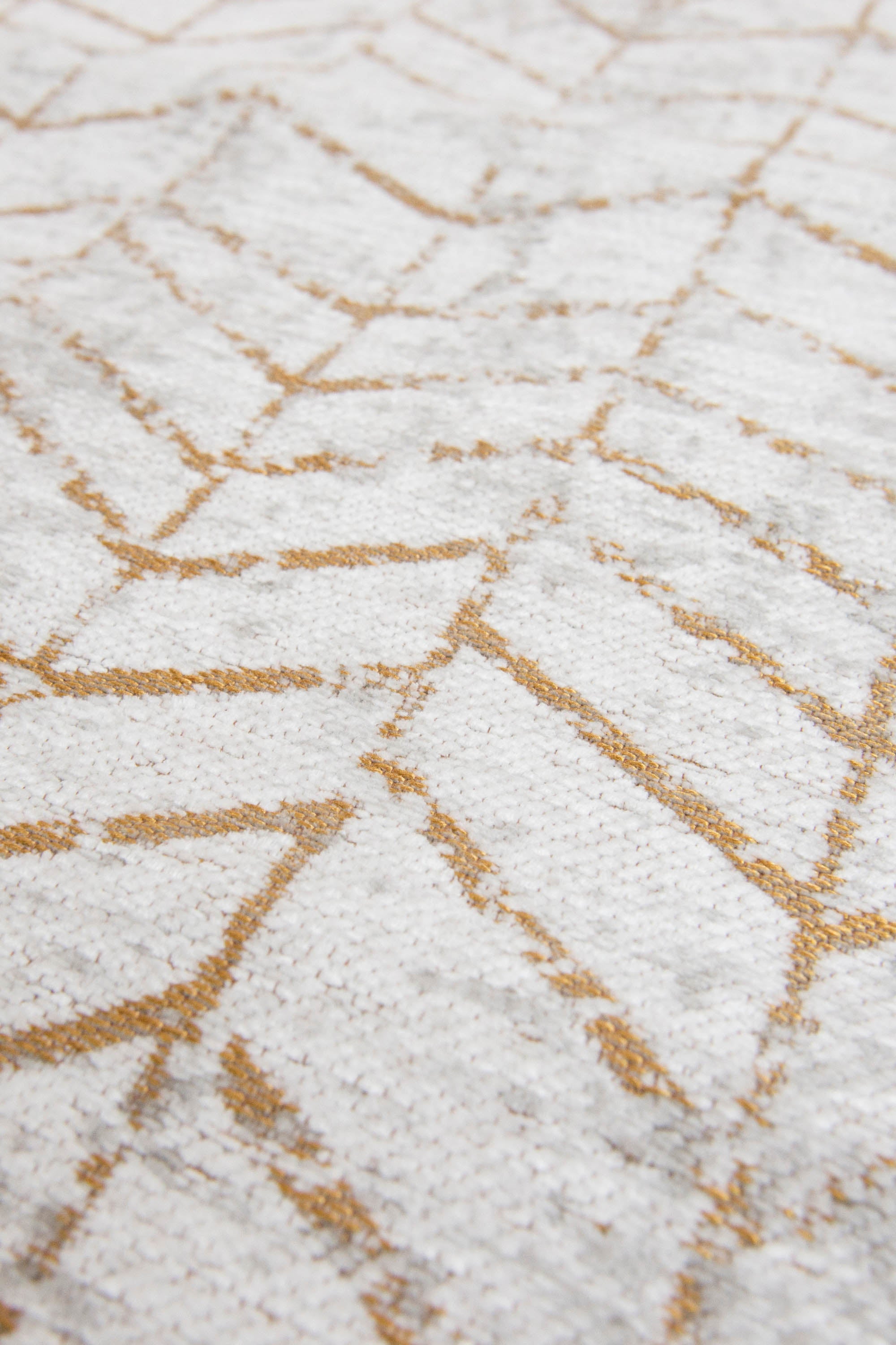 White flatweave runner rug with faded yellow chevron pattern