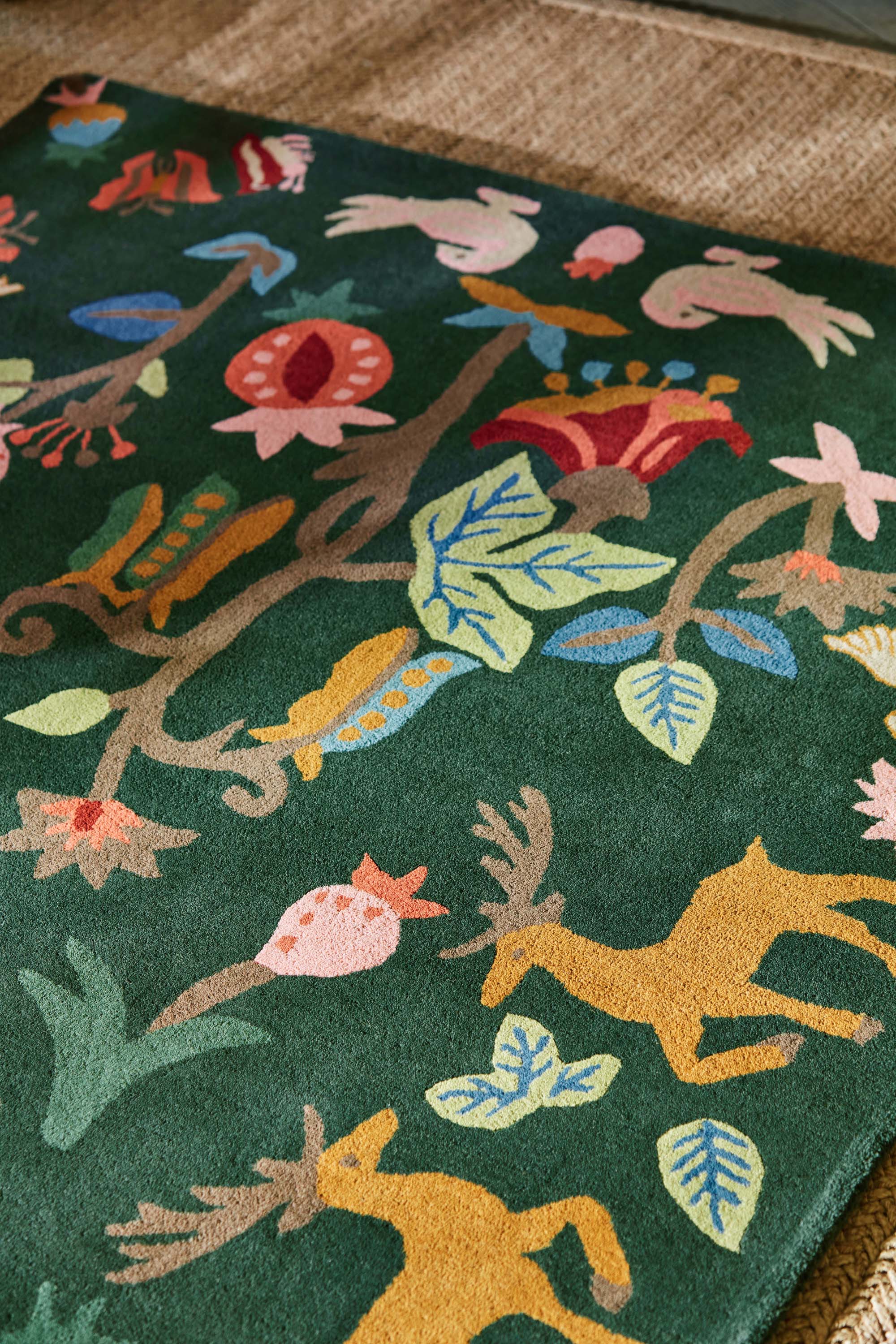 Green rug with woodland motif