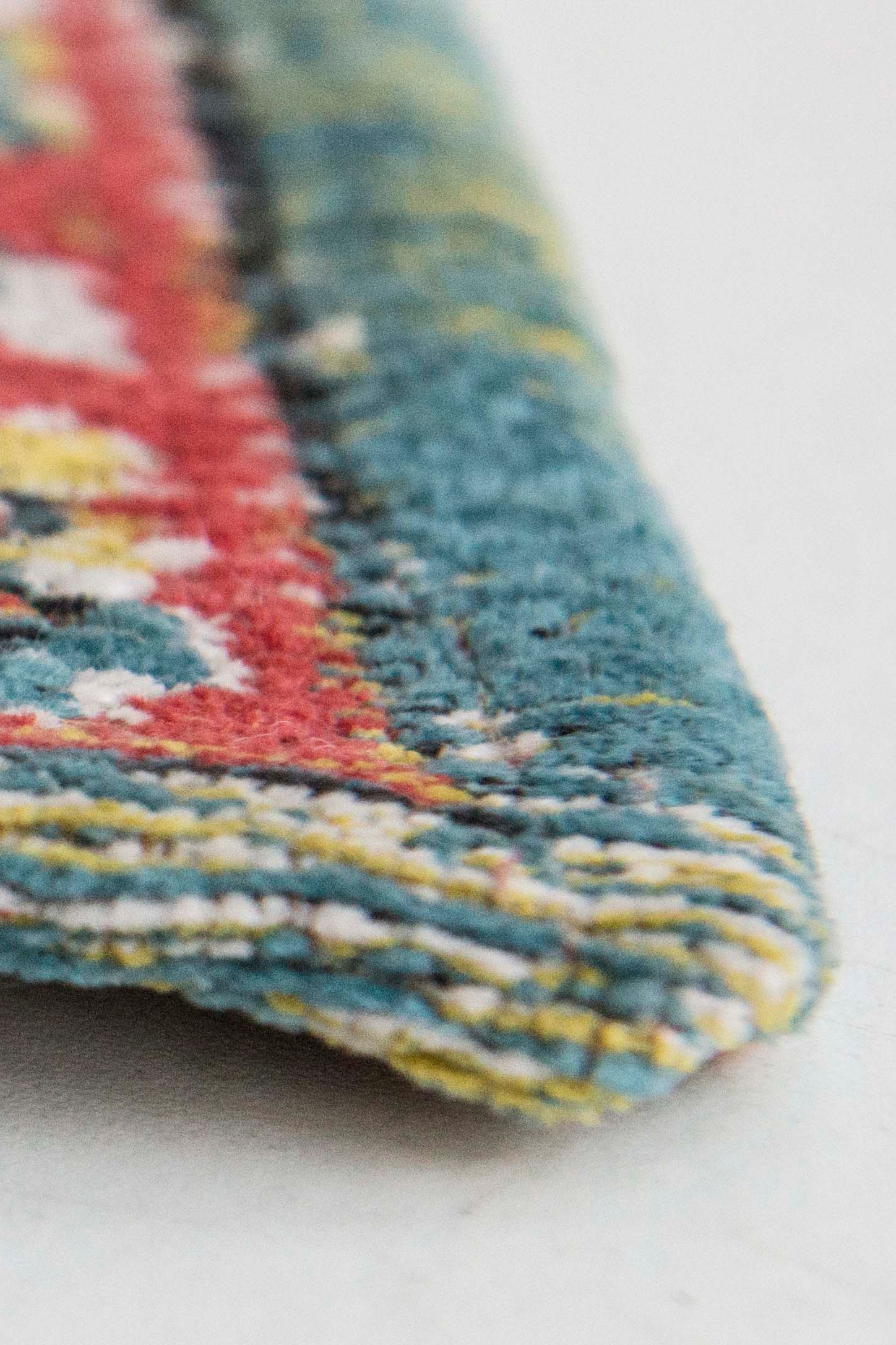 Flatweave rug with faded persian design in blue, red and yellow