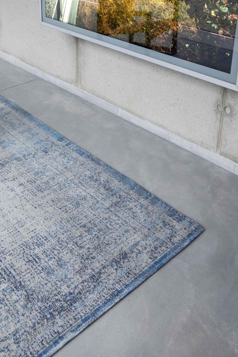 blue and grey flatweave rug with traditional medallion design
