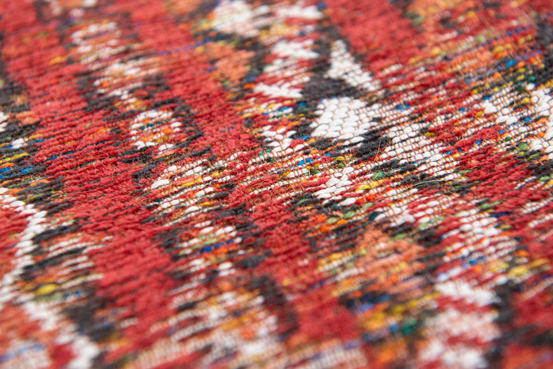 red rug with a moroccan geometric pattern