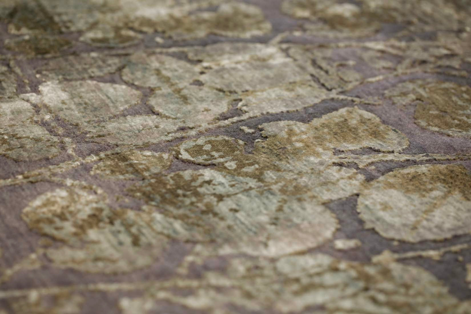 grey and taupe rug with an abstract damask pattern