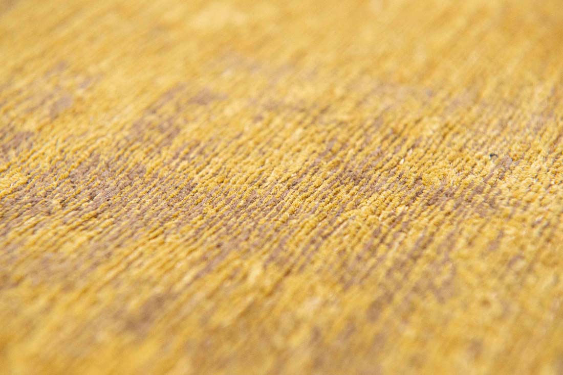 gold flatweave rug with modern abstract design