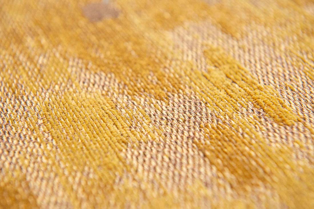 gold flatweave rug with modern abstract design