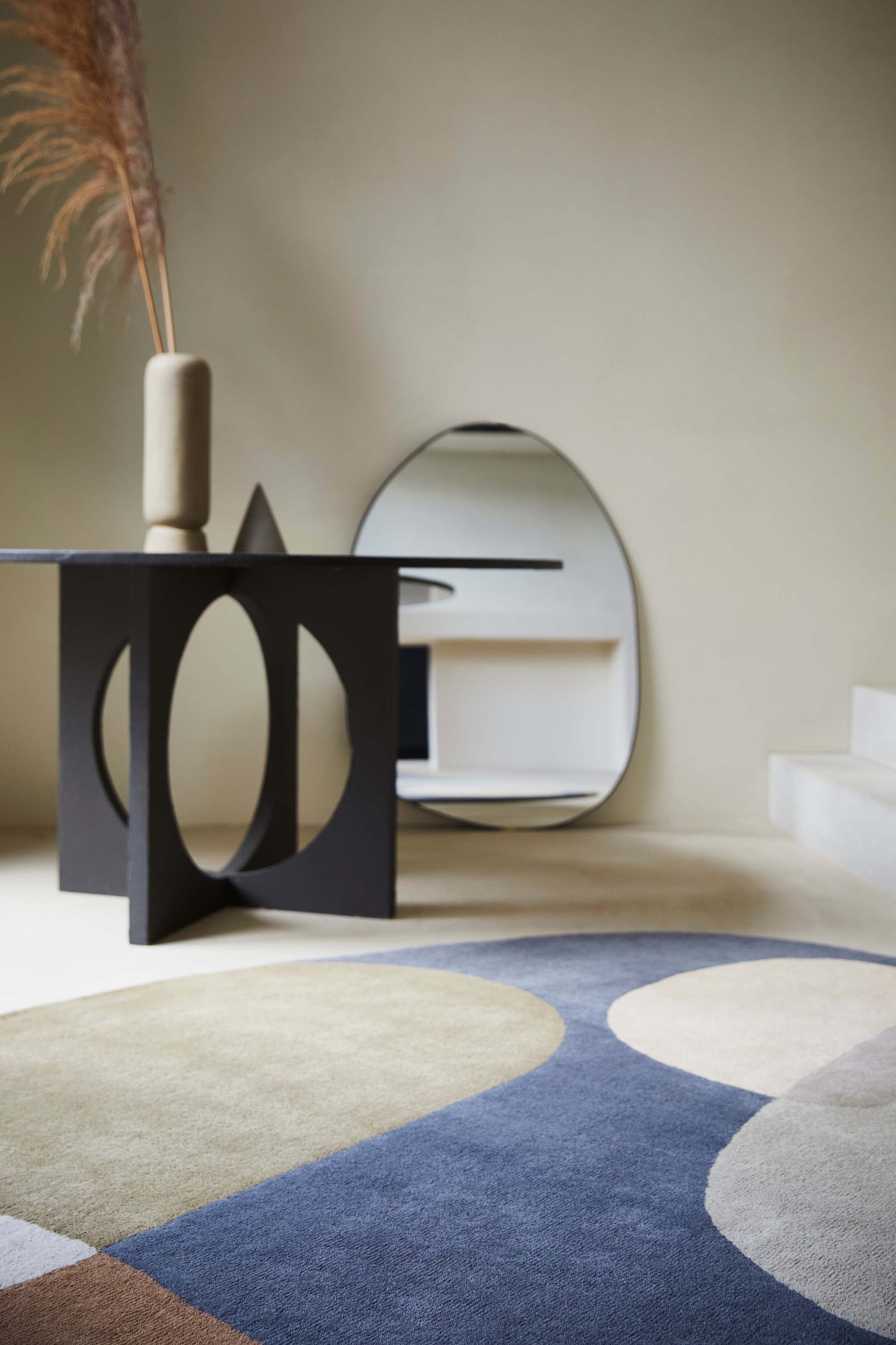 multicolour oval shaped wool rug with abstract design