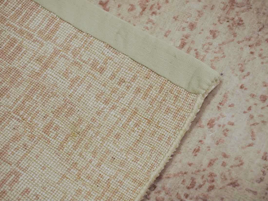 Pink and beige abstract area rug