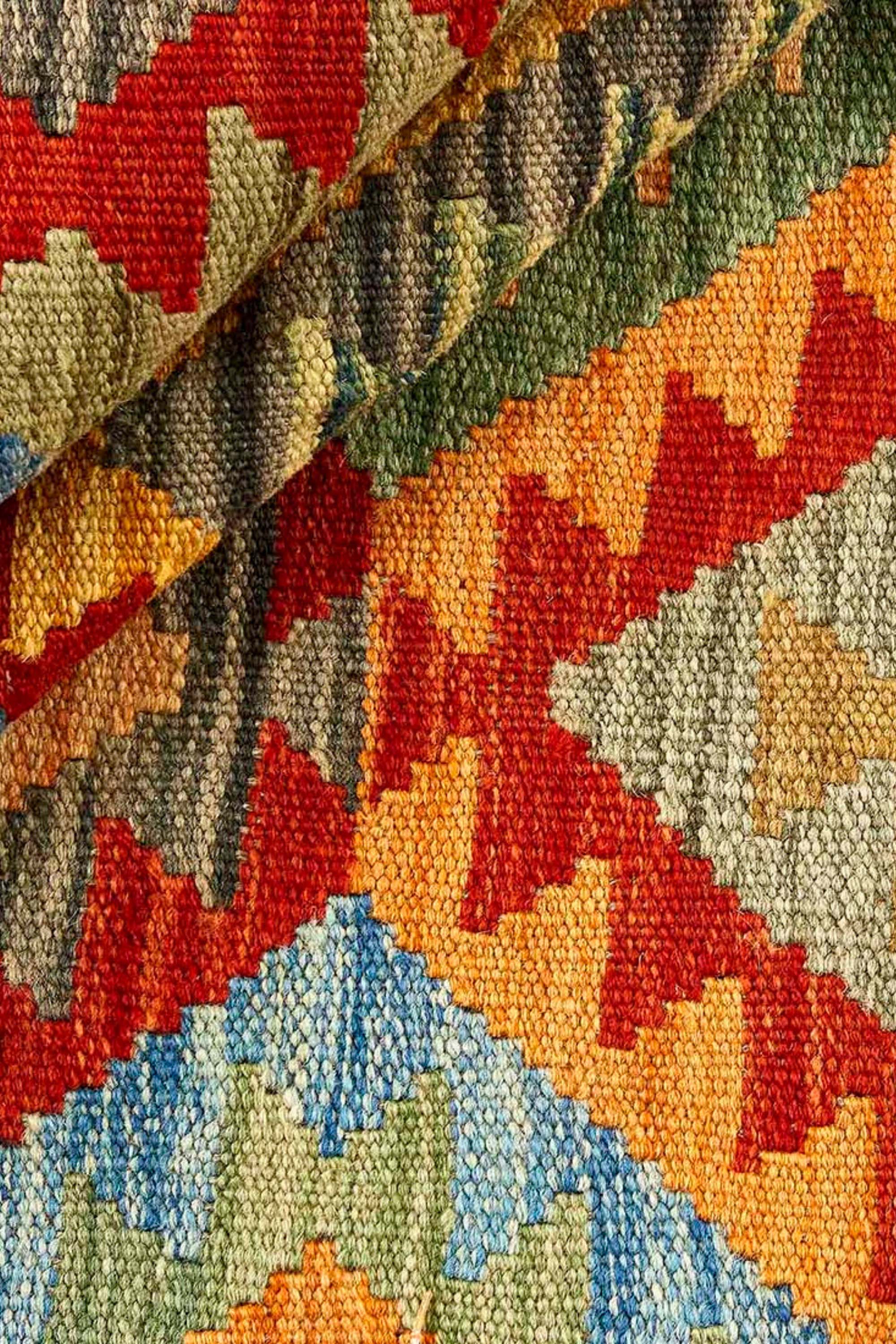 oriental kelim flatweave rug with a geometric design in blue, red, yellow, green, beige and orange