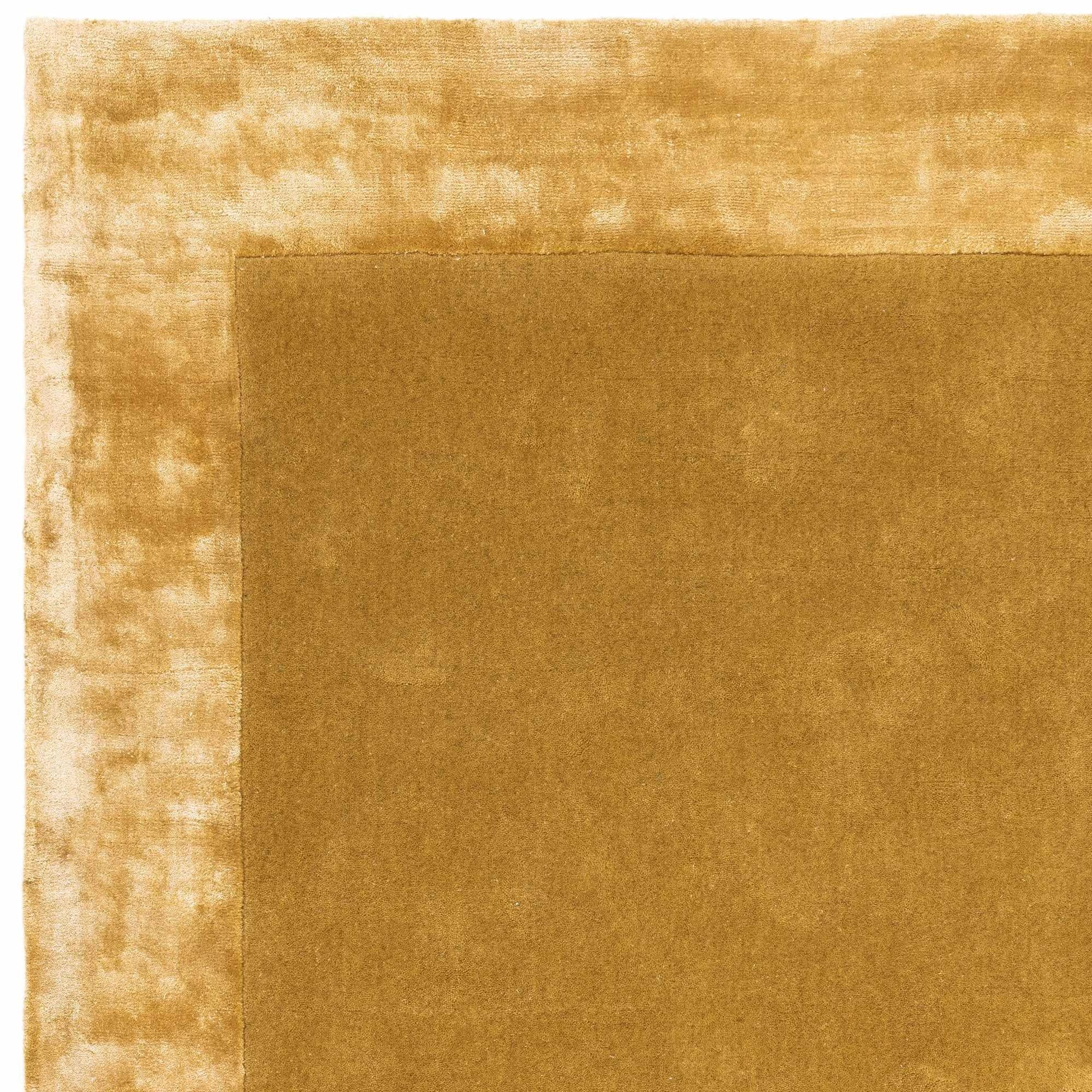 Gold wool and viscose rug with a border design