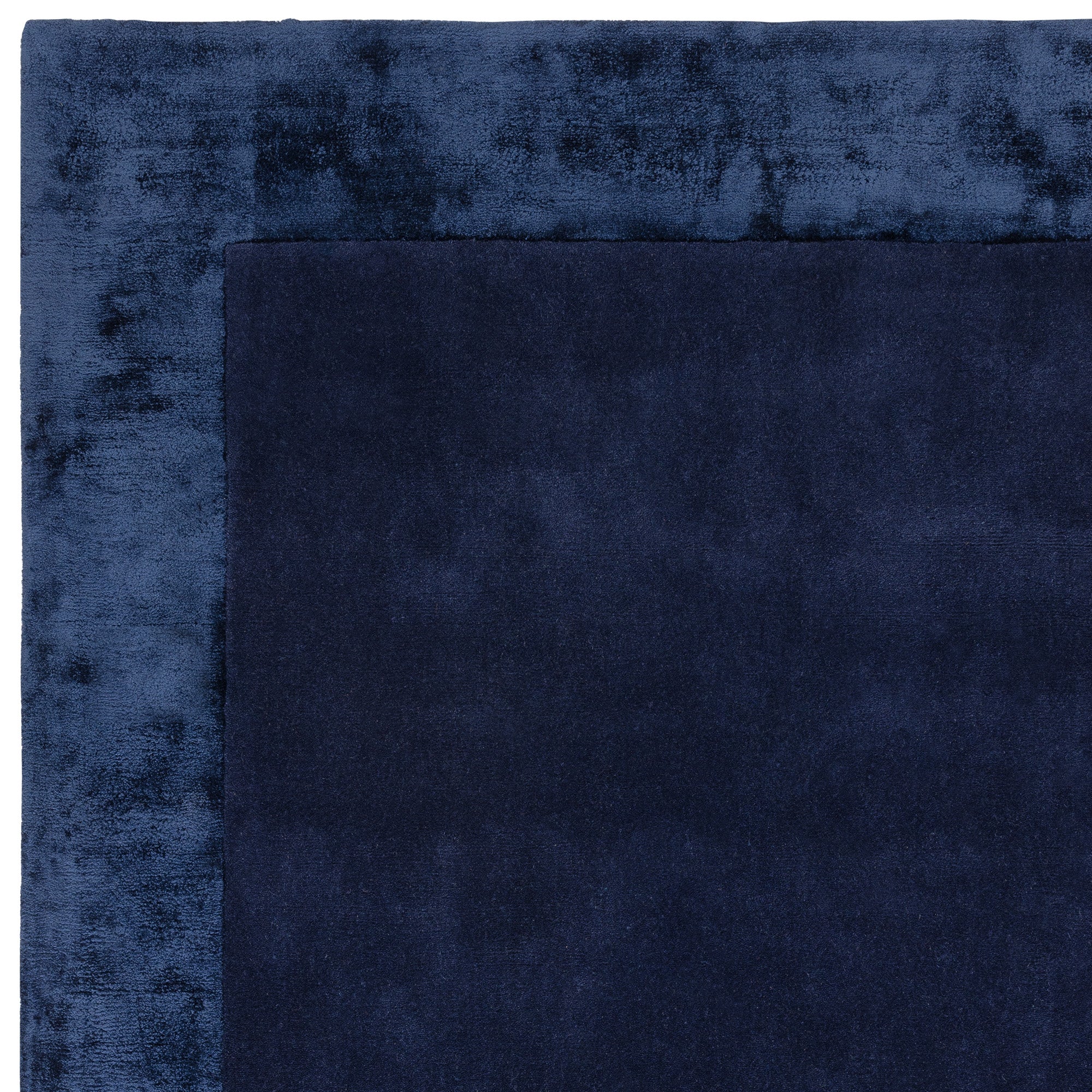Navy wool and viscose rug with a border design