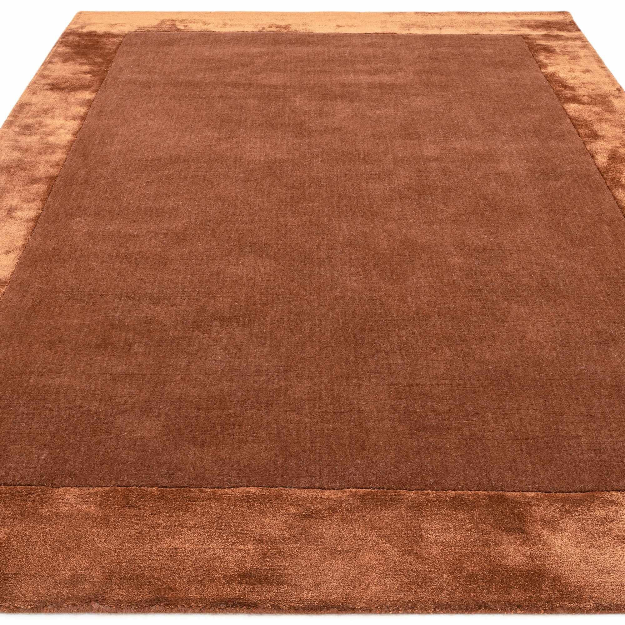 Orange wool and viscose rug with a border design