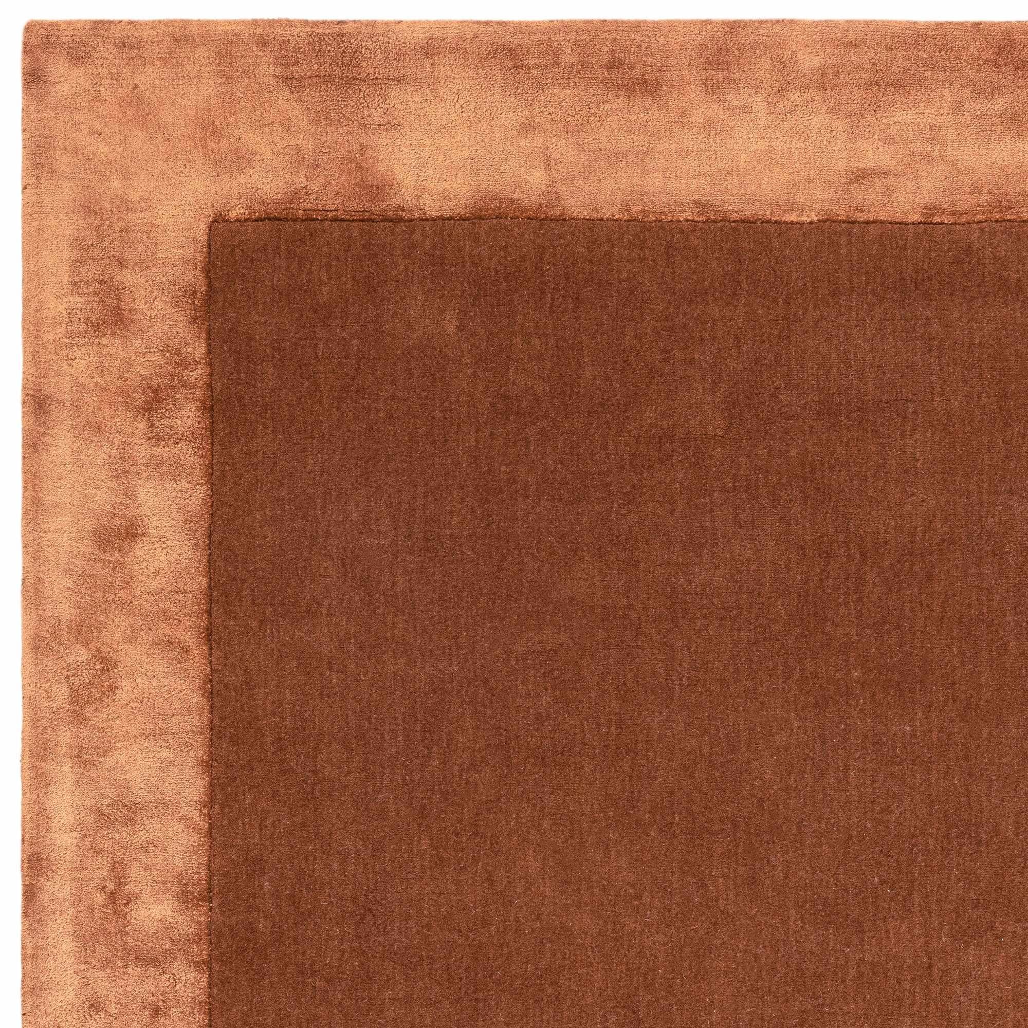 Orange wool and viscose rug with a border design