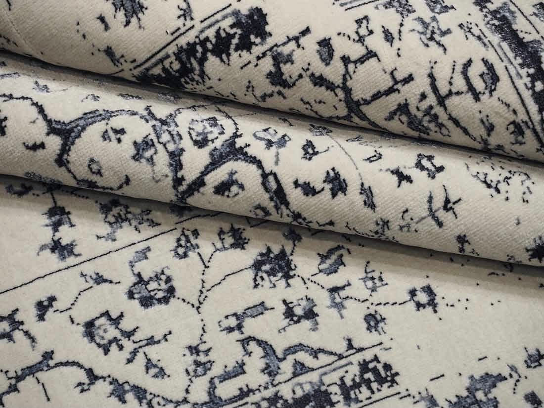 cream and blue oriental rug with a floral design