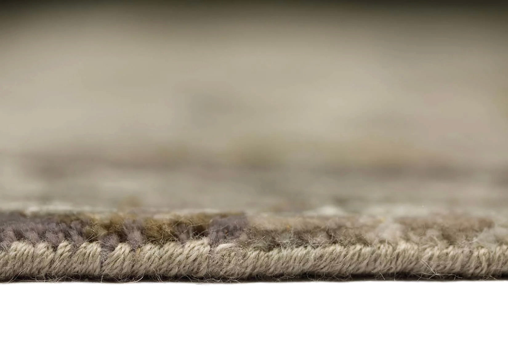 grey and taupe rug with an abstract damask pattern
