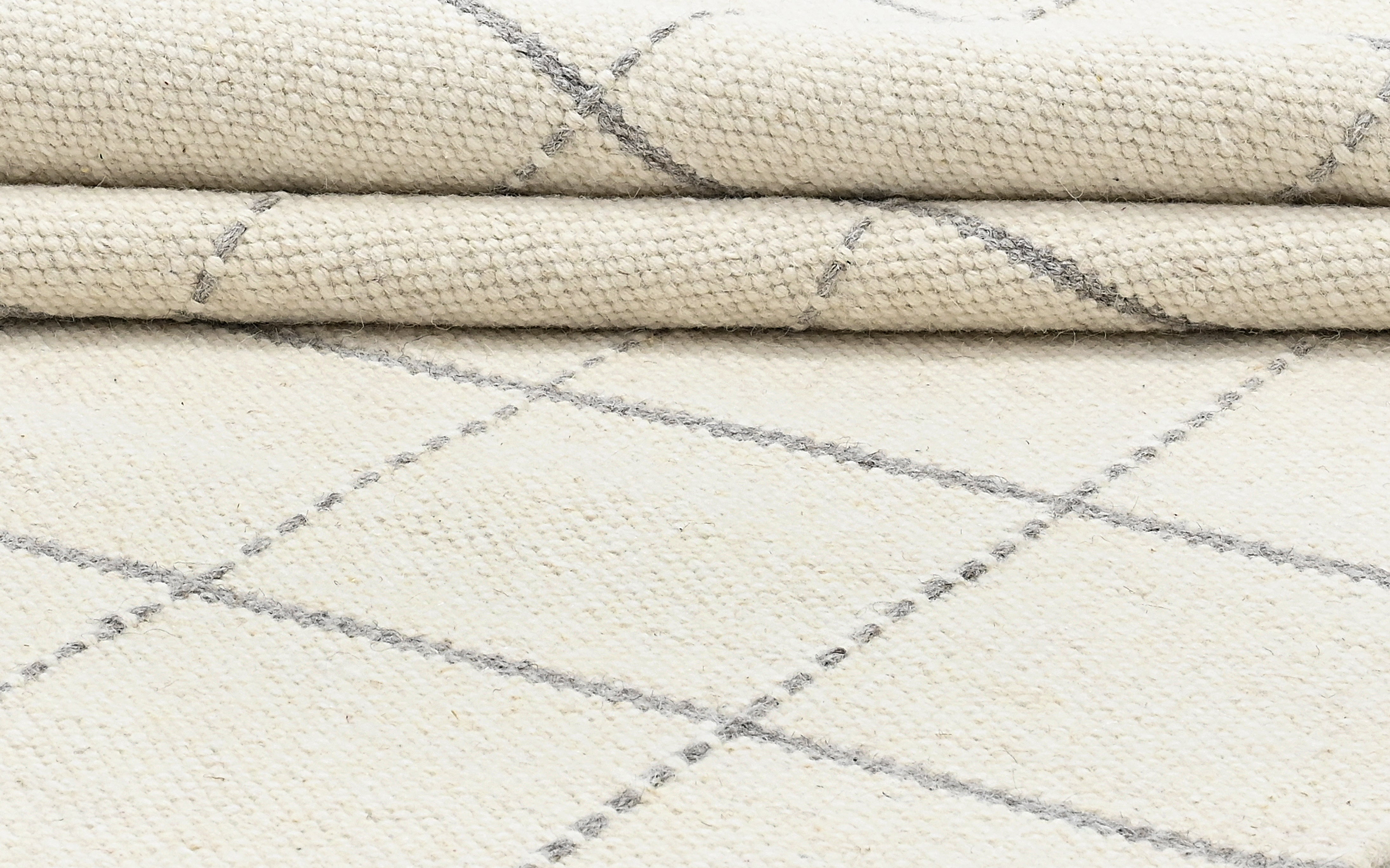 White wool and cotton area rug with grey checkered design