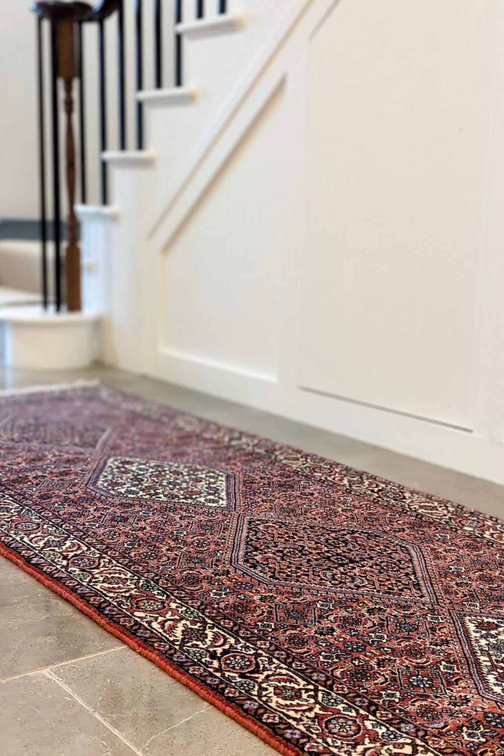 Red and cream persian runner with traditional floral design