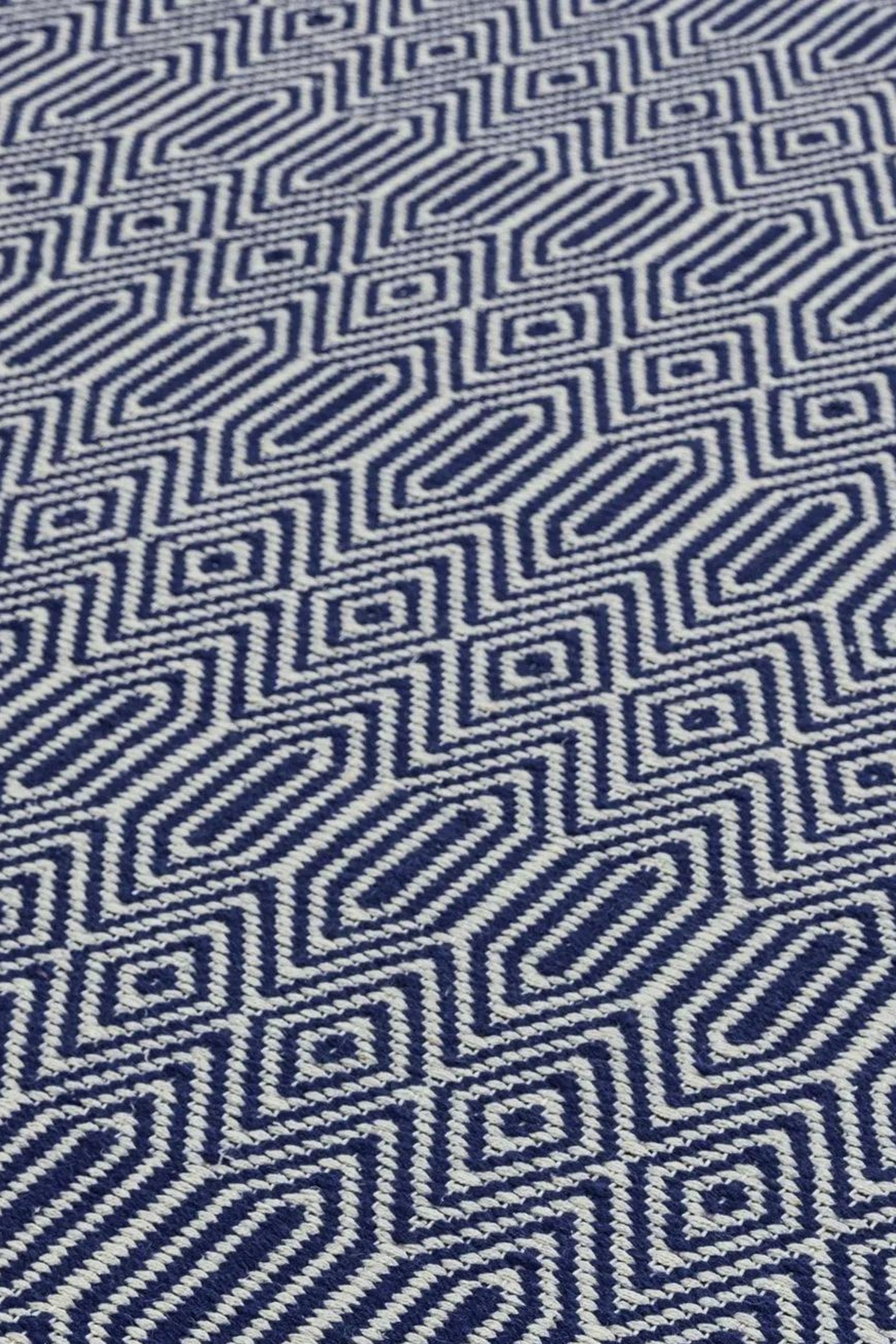 blue and white woven rug with aztec chevron pattern