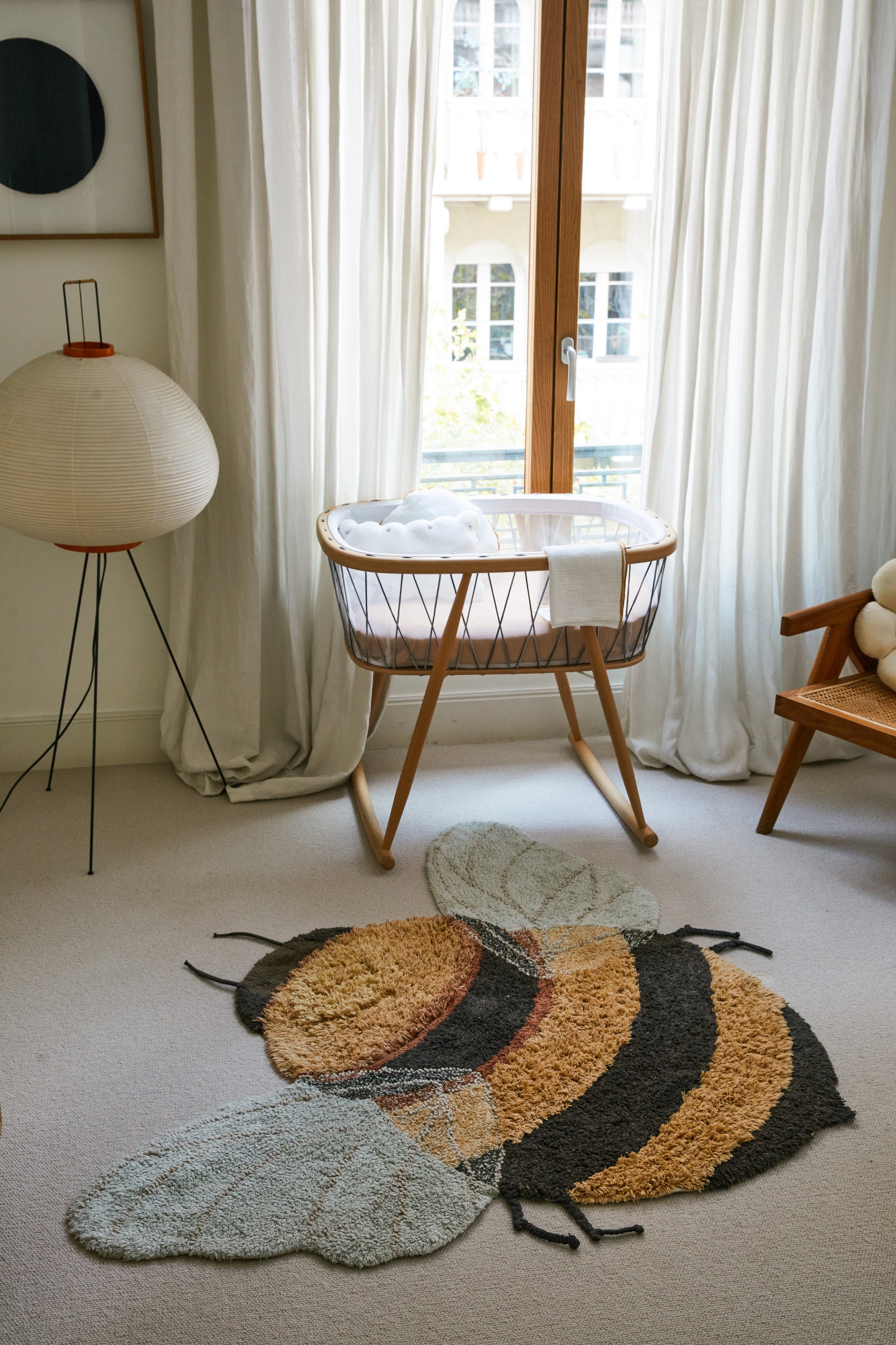 Bee-shaped rug with shades of gold, orange, brown, cream, and beige