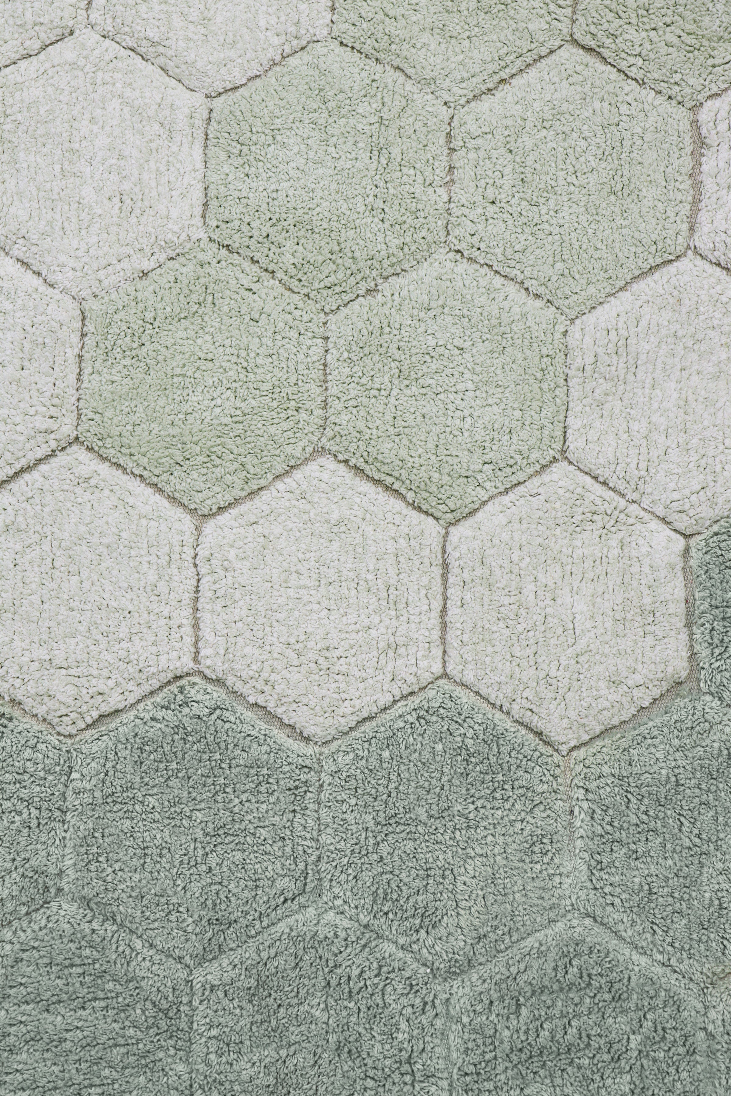 Round blue and sage rug with honeycomb pattern