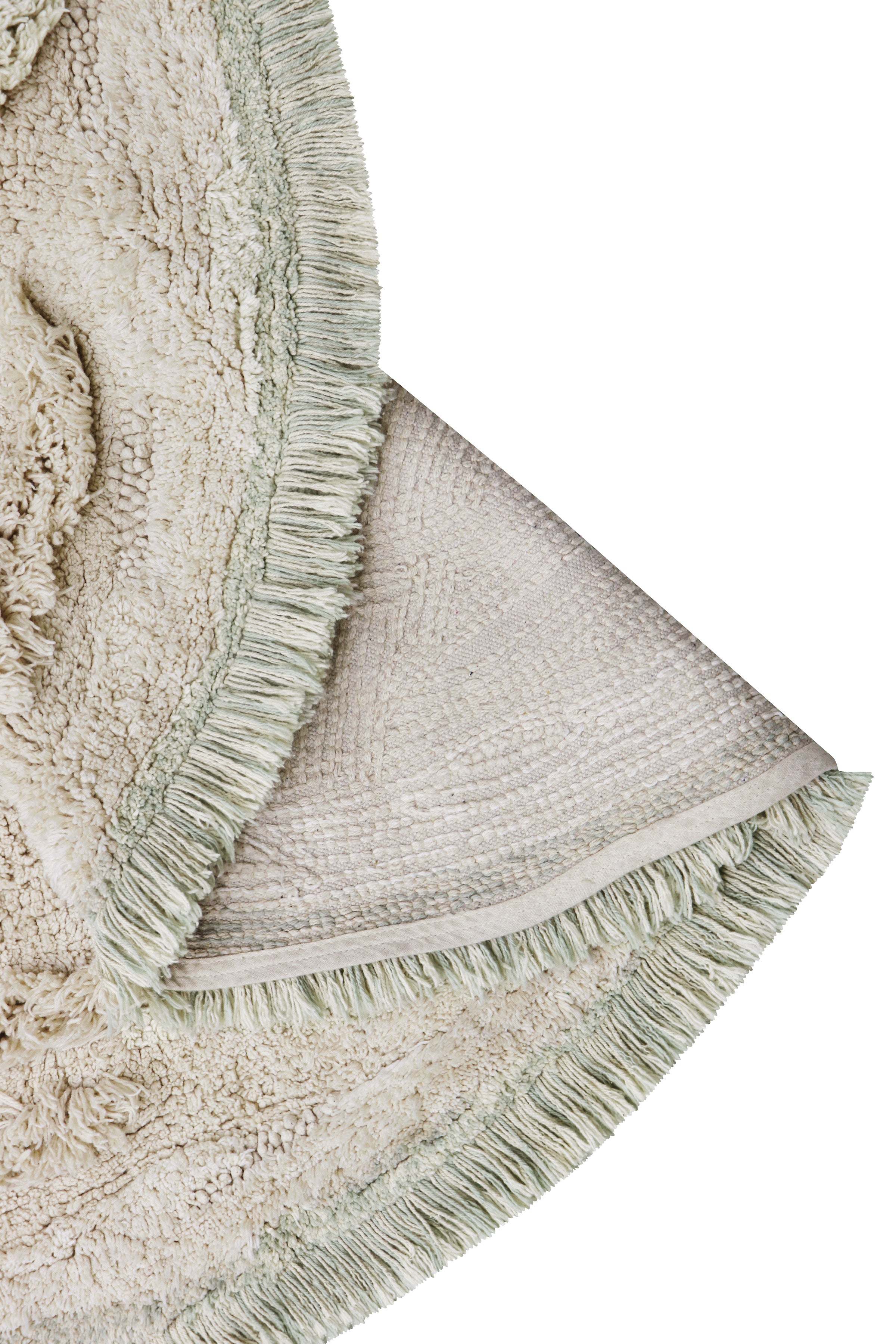 Beige island inspired rug with green fringing and added beach toys