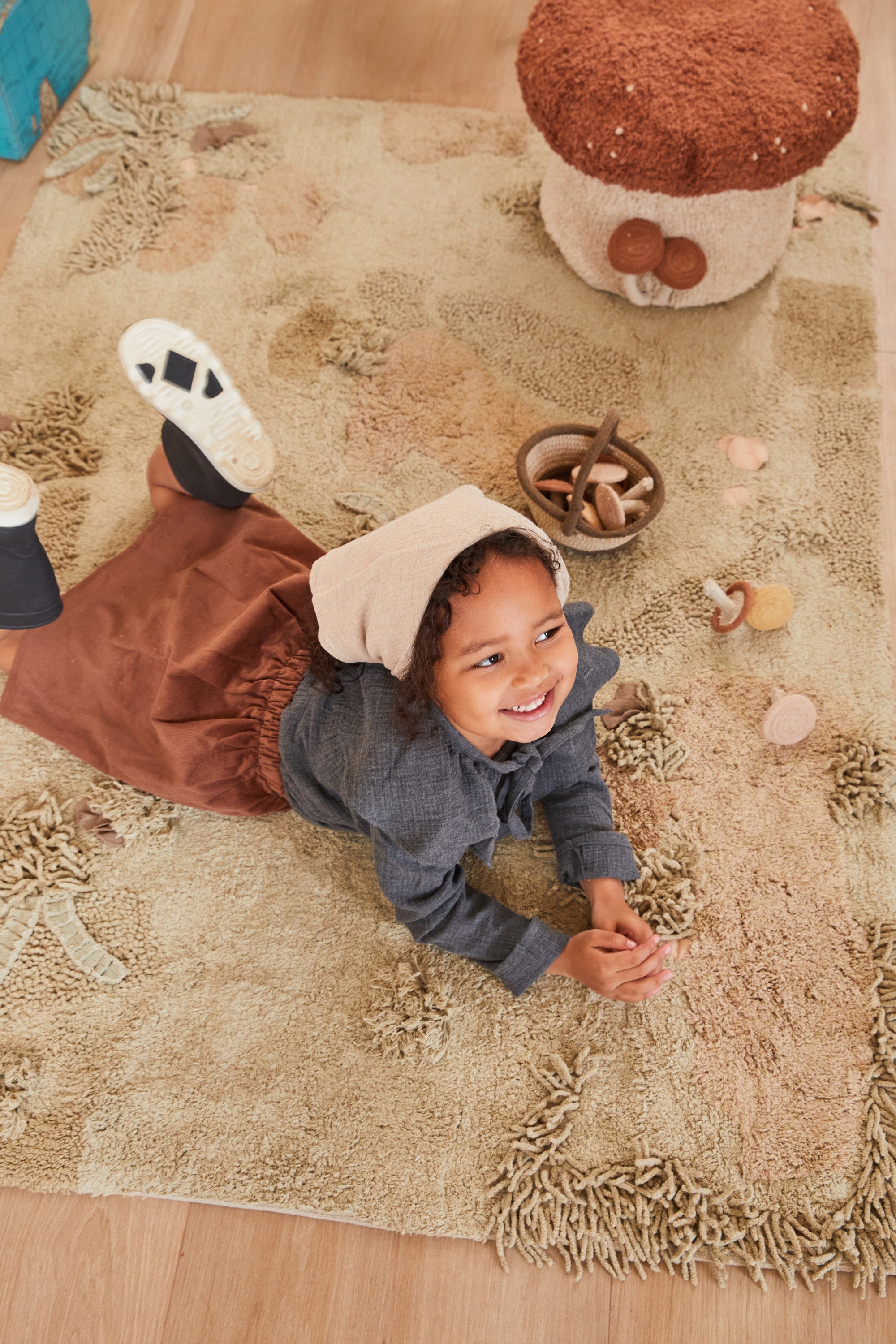 Green forest inspired rug with added mushroom toys