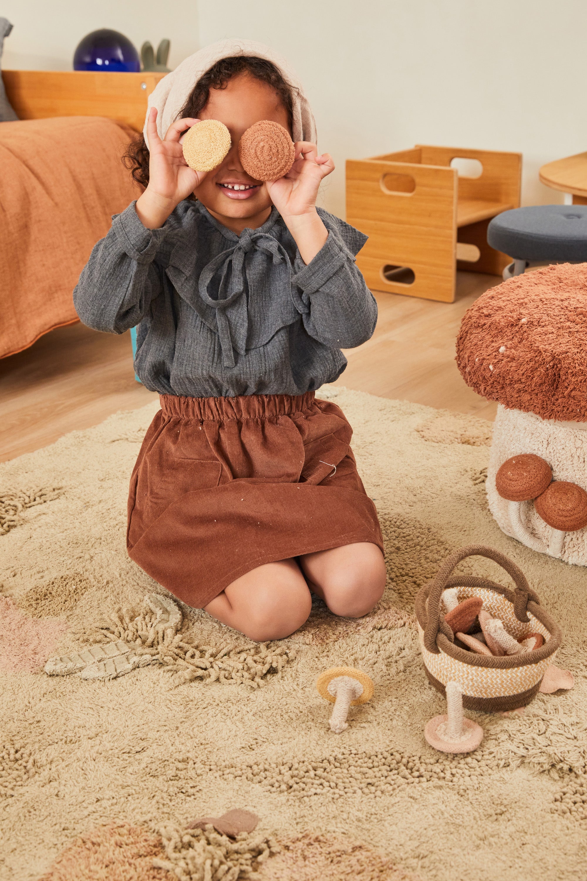 Green forest inspired rug with added mushroom toys