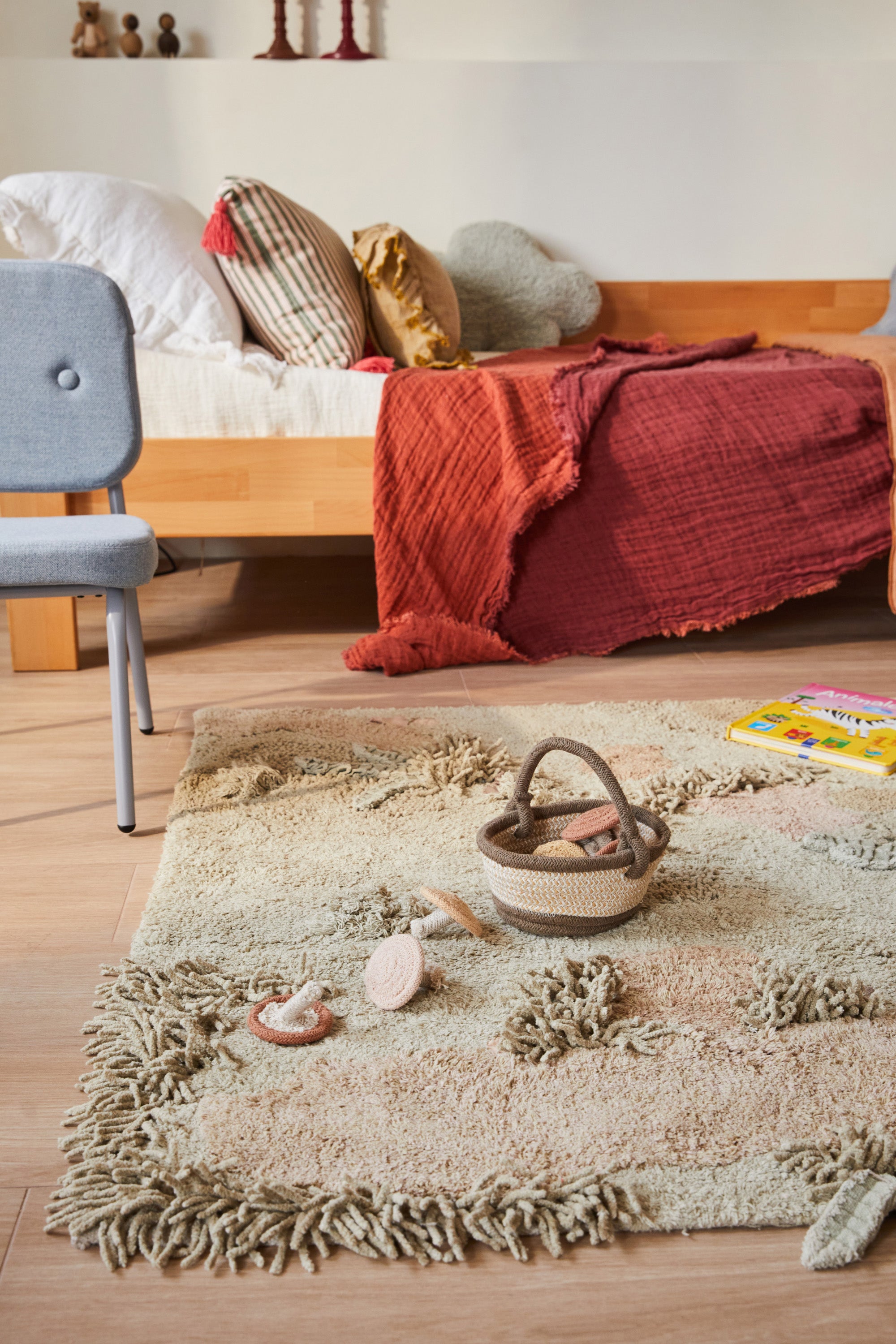 Green forest inspired rug with added mushroom toys