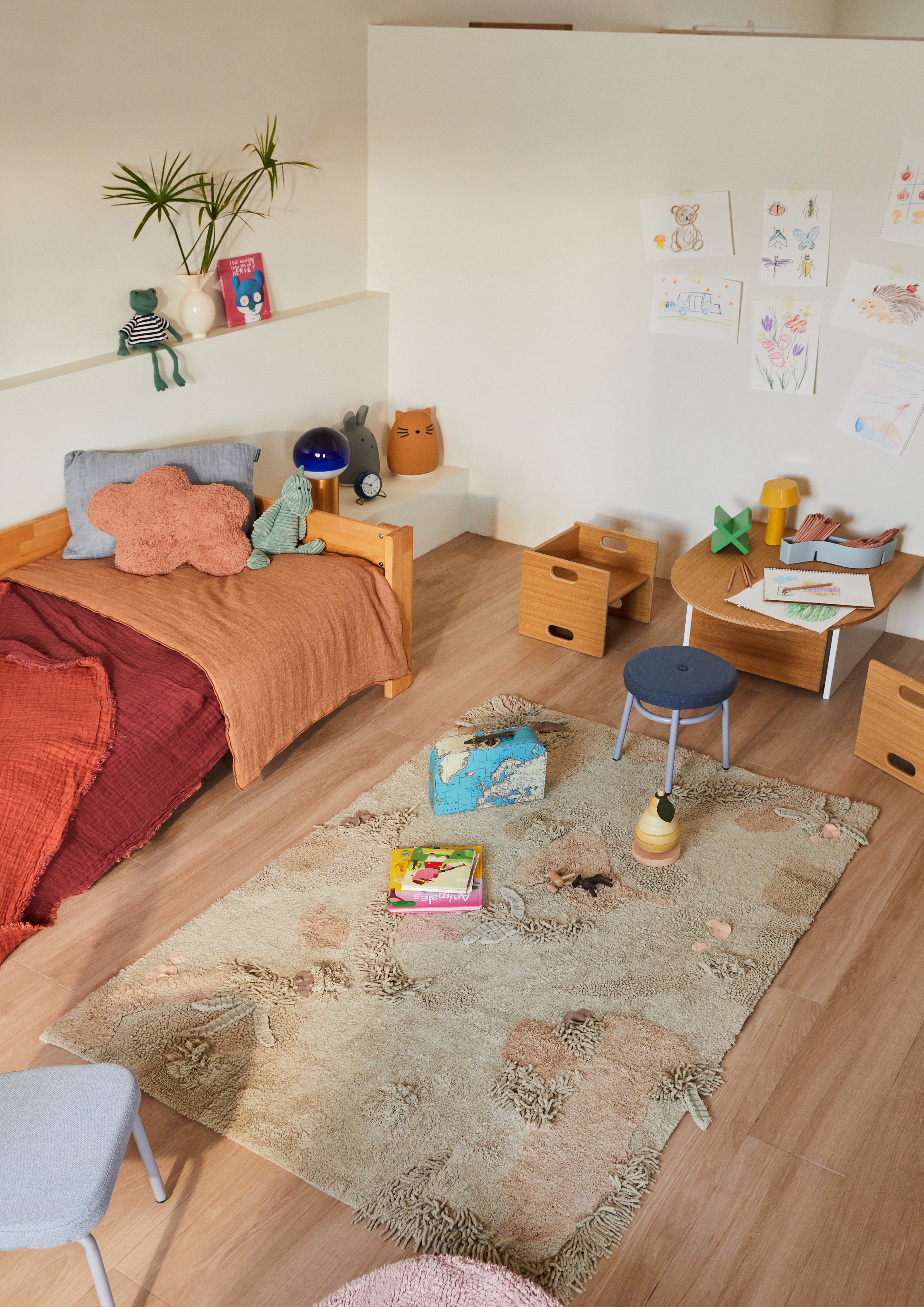 Green forest inspired rug with added mushroom toys