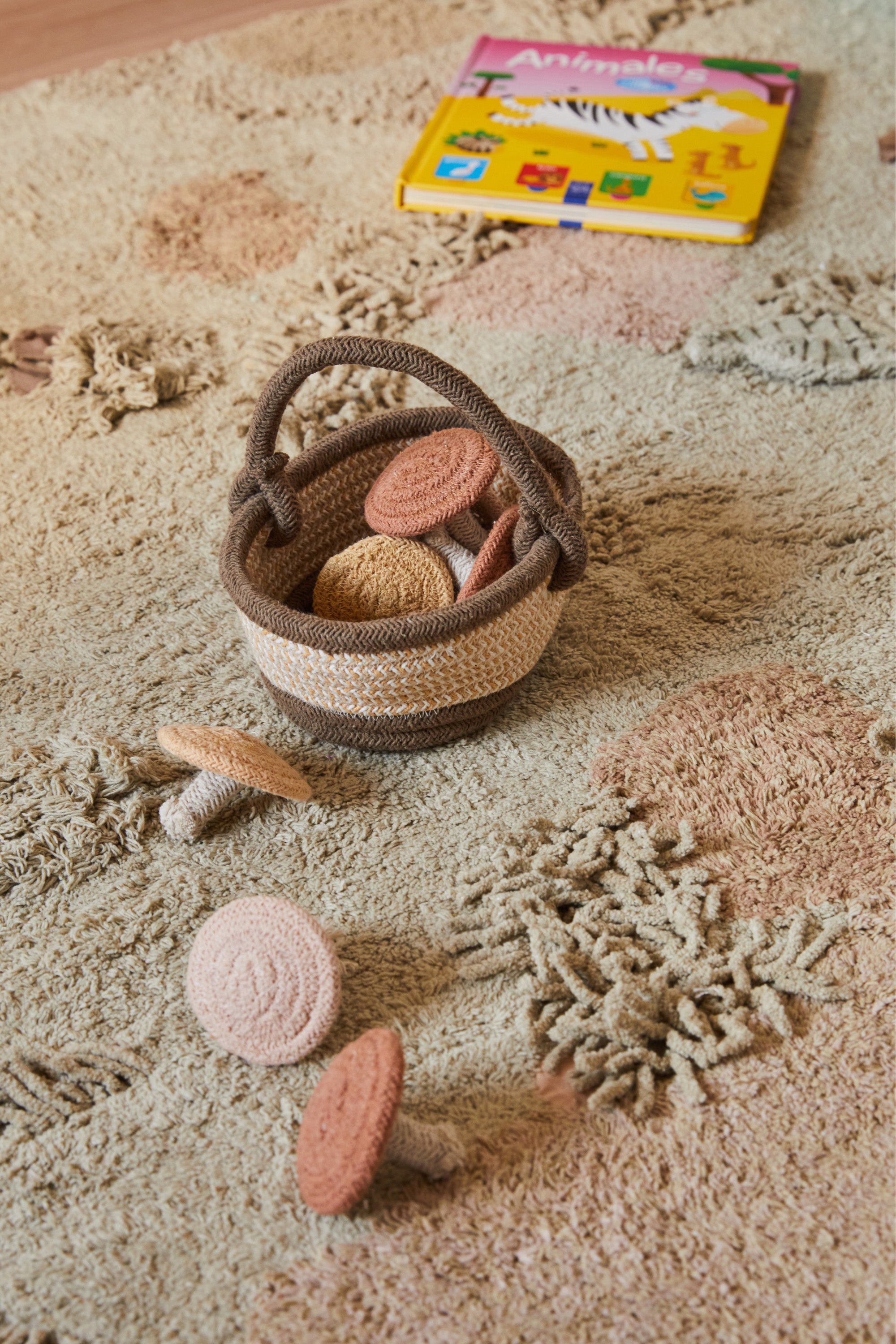 Green forest inspired rug with added mushroom toys