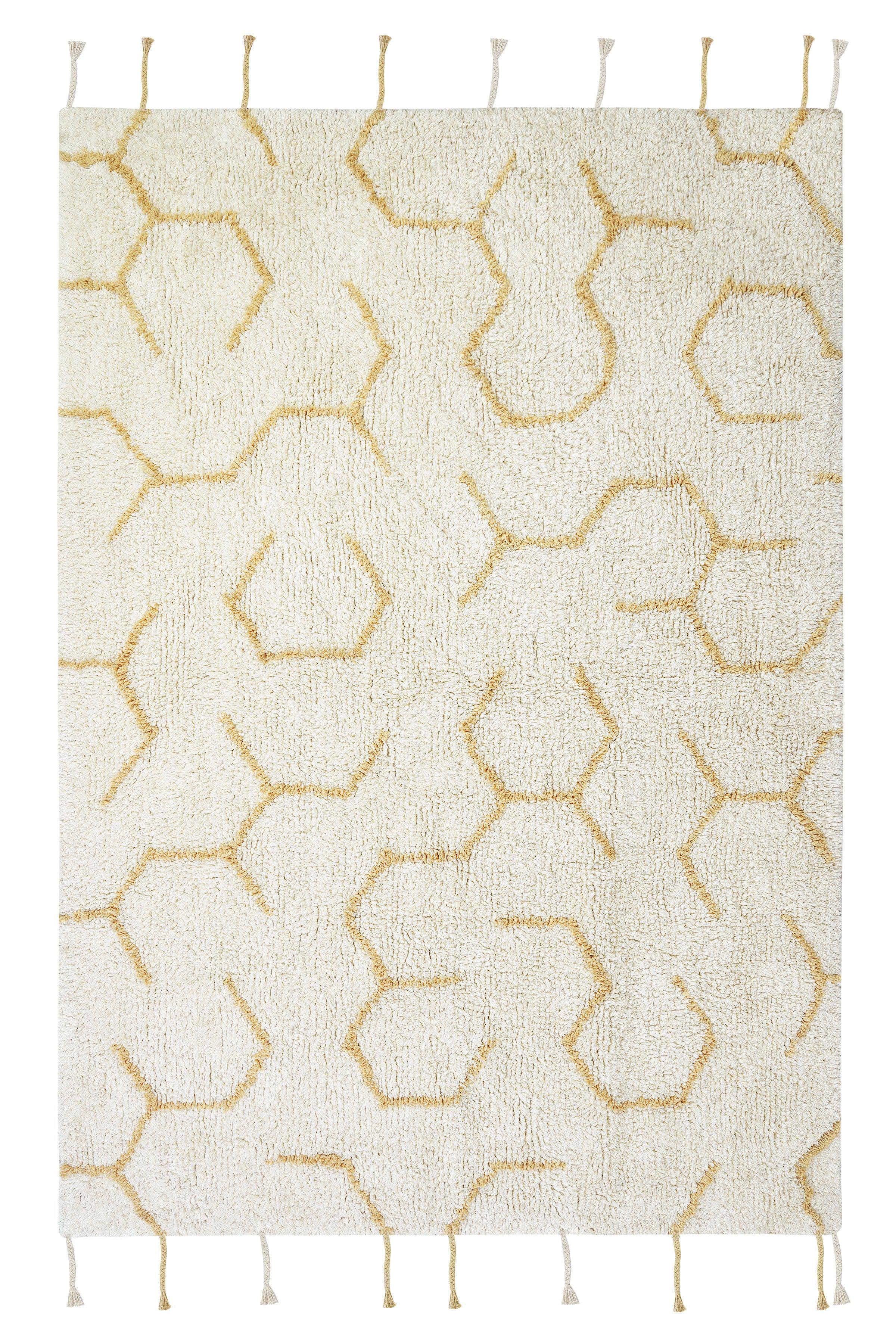 Cream rug with minimal yellow honeycomb pattern and honeybee toys