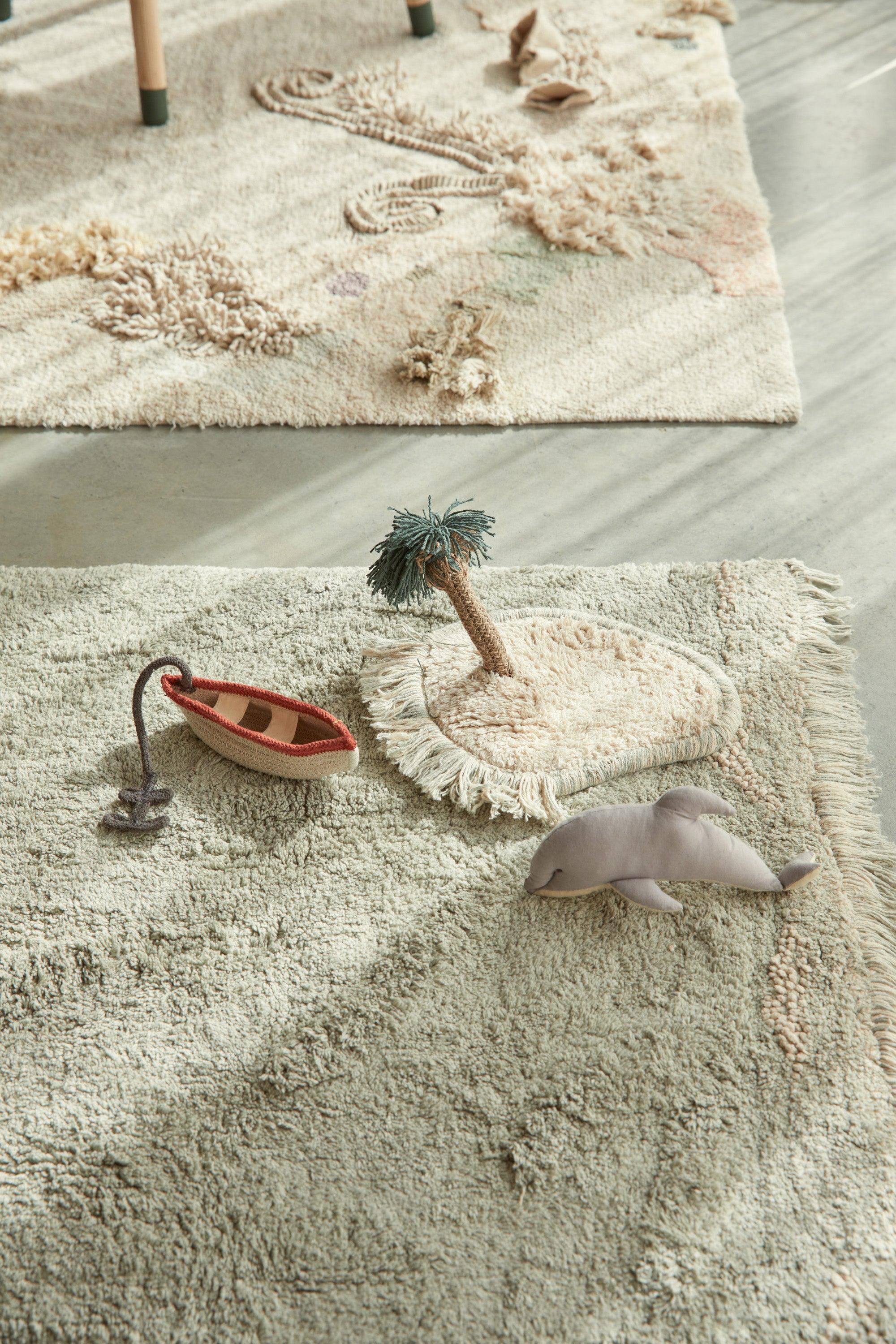 Green plain ocean waves inspired rug with added toys