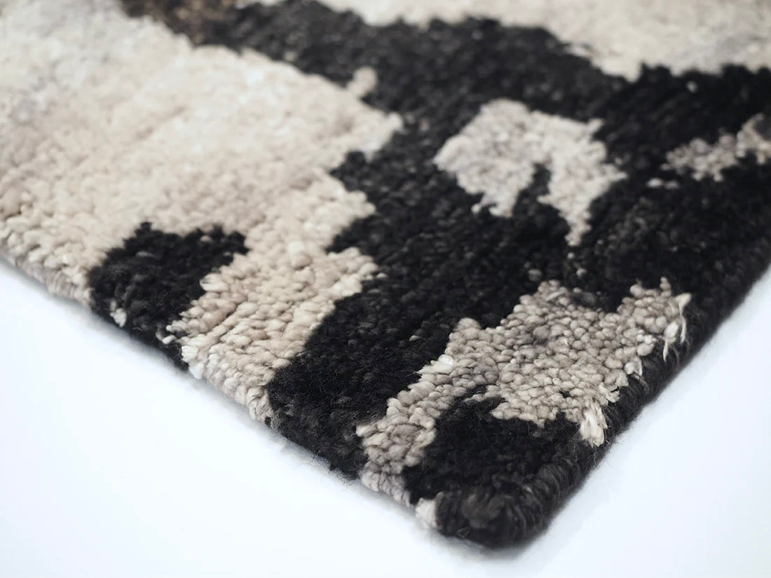 oriental rug with an abstract traditional pattern in grey