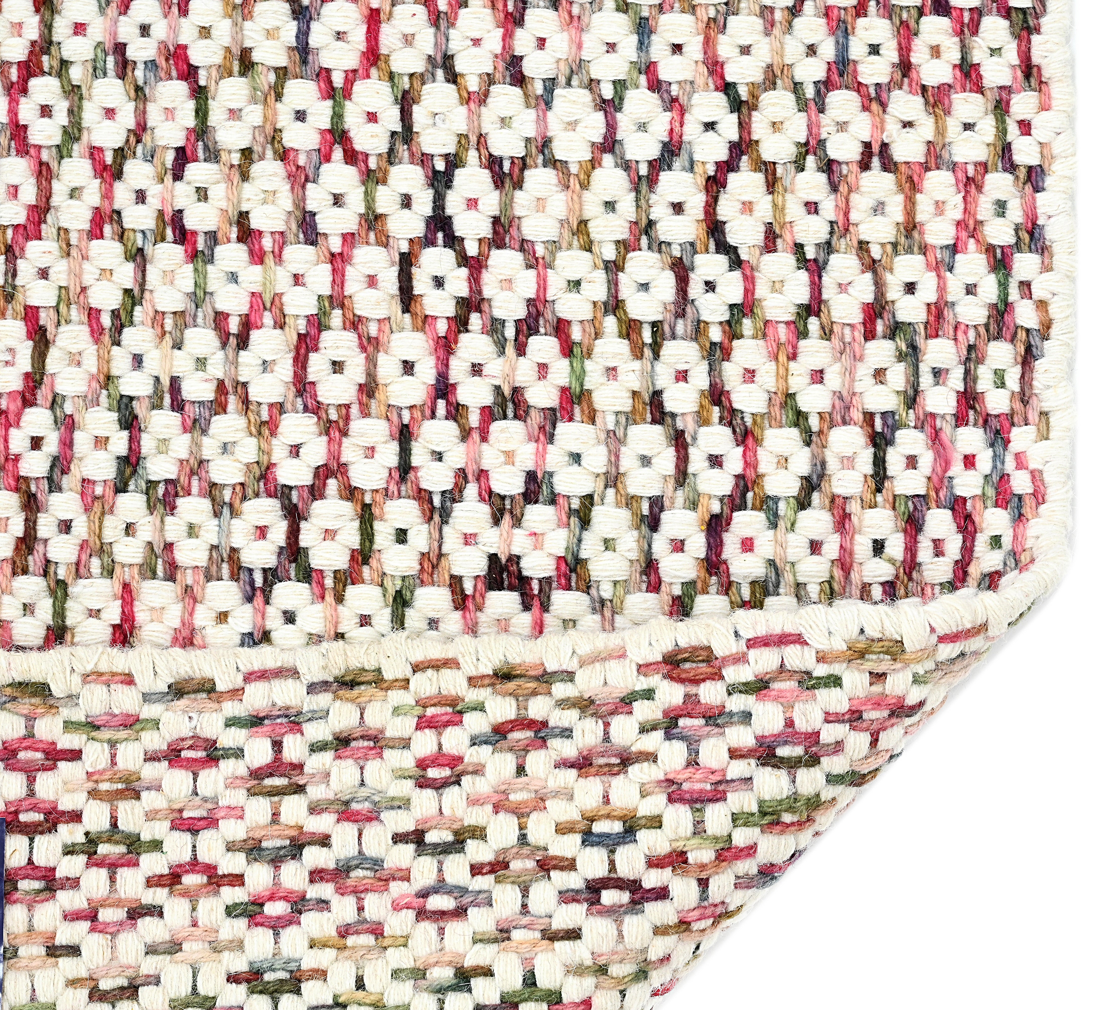 Textured wool rug with pink, blue and green yarns throughout