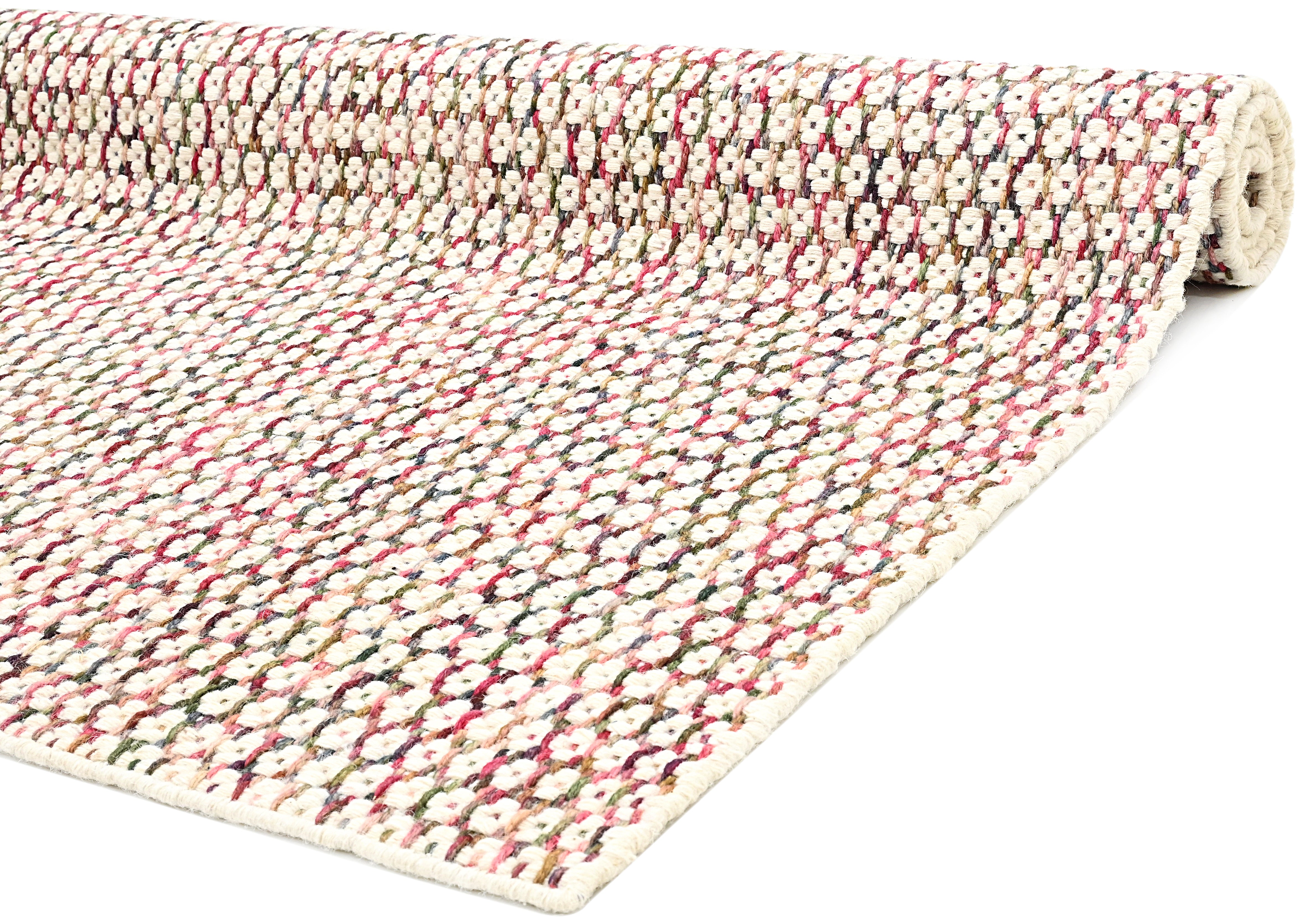 Textured wool rug with pink, blue and green yarns throughout