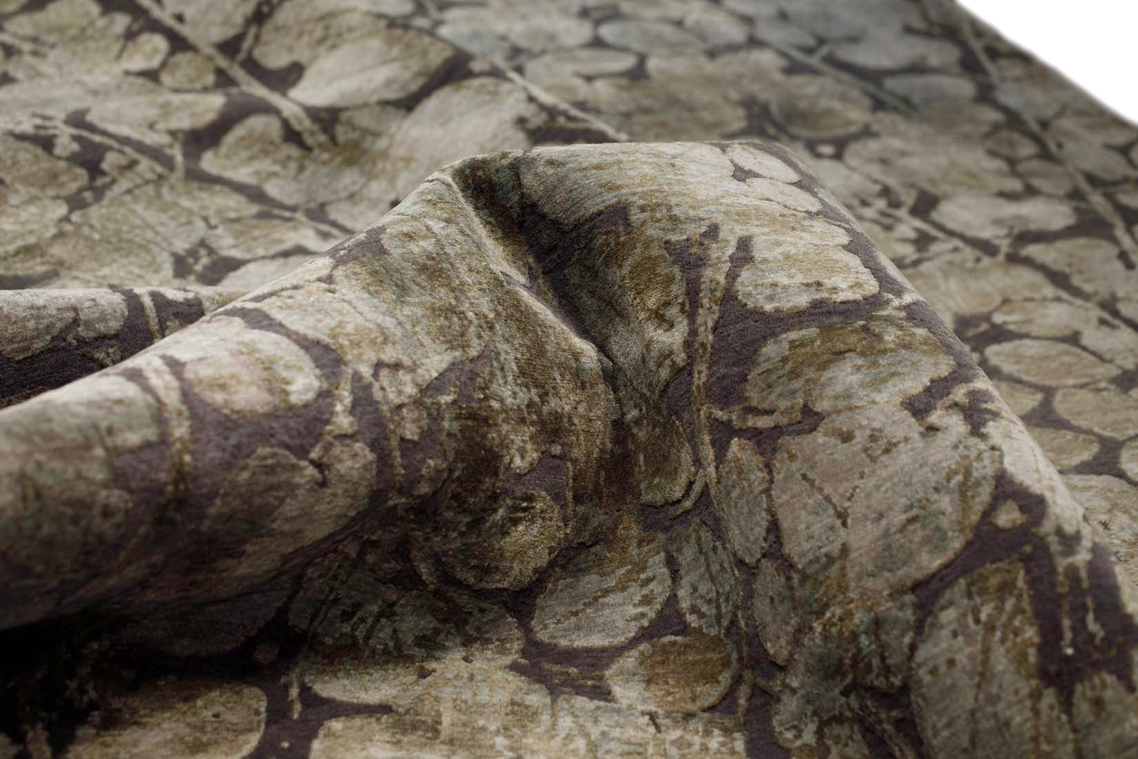 grey and taupe rug with an abstract damask pattern