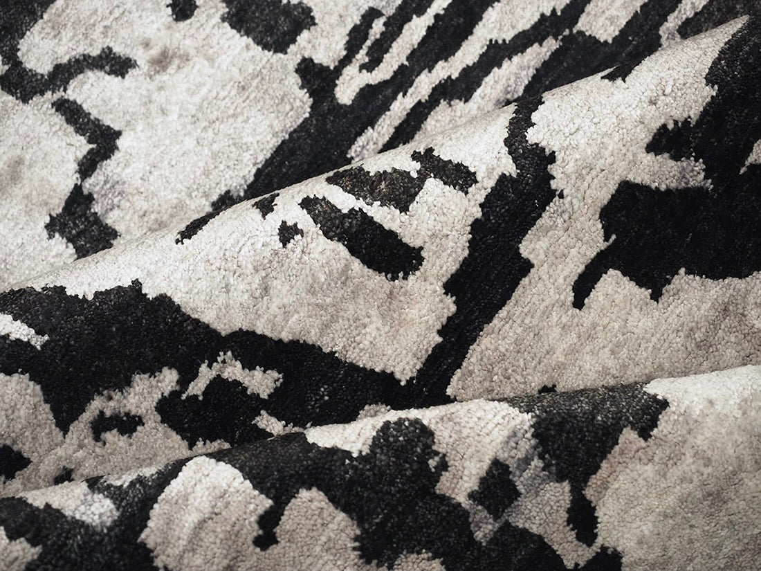 oriental rug with an abstract traditional pattern in grey